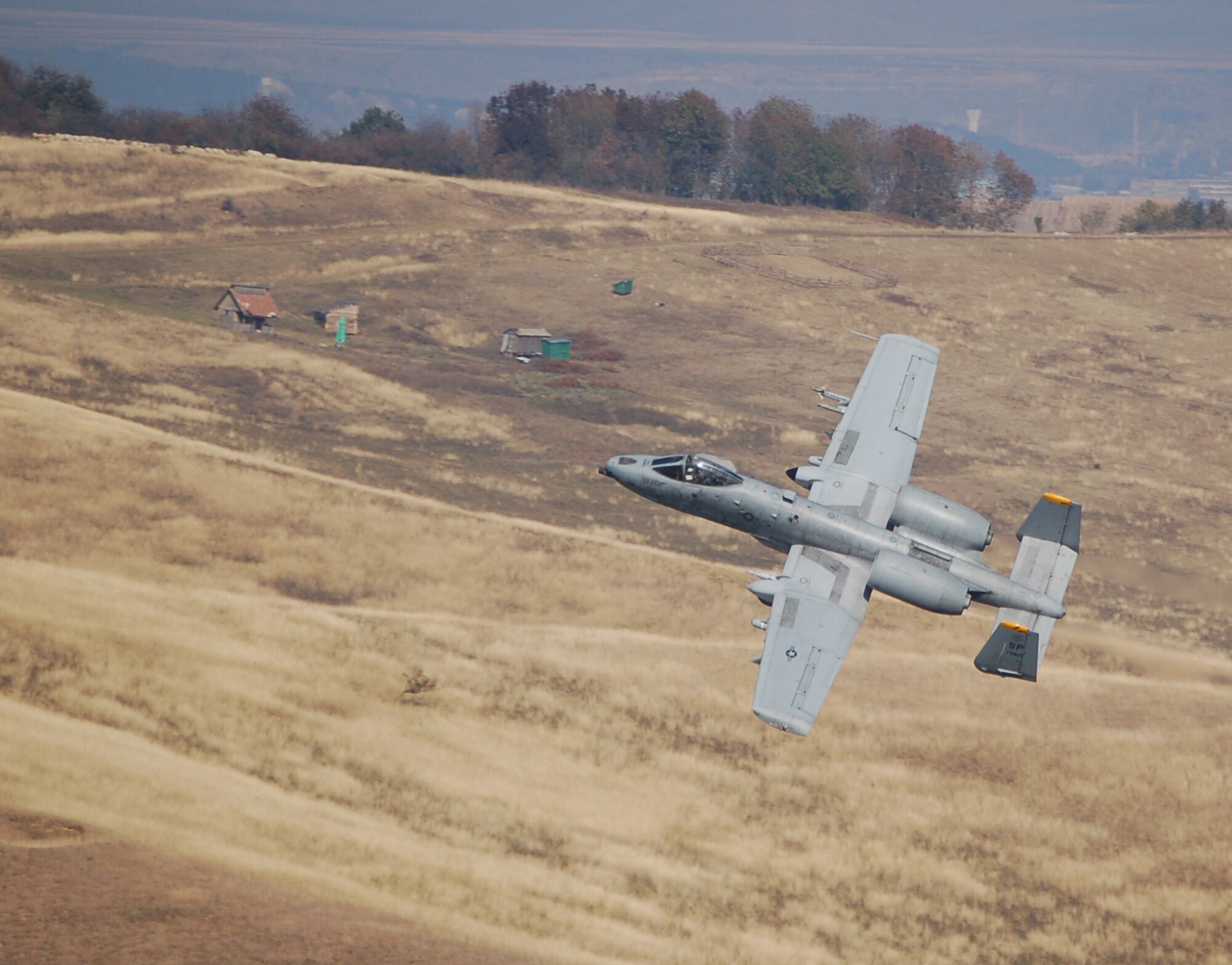 CAMPIA-TURZII, Romania -- An 81st Fighter Ssquadron pilot prepares to shoot the A-10 Thunderbolt II's 30 mm seven-barrel Gatling gun during training at a range here Oct. 22. Precise weapons delivery is one of the 81st FS’ priorities while training here, as pilots are able to utilize many of the A-10s capabilities. “This deployment offers tremendous training opportunities for an A-10 squadron,” said Lt. Col. Ronald Stuewe, 81st FS commander. “We plan on maximizing the events that are difficult to obtain from home station – low altitude, chaff and flare employment, and basic weapons delivery.  The potential ability to utilize our Data-Link (a computer network for communication between aircraft) will be critical in the European Command Area of Responsibility and will truly allow the squadron to train like we fight.” (U.S. Air Force photo/2nd Lt. Kathleen Polesnak)