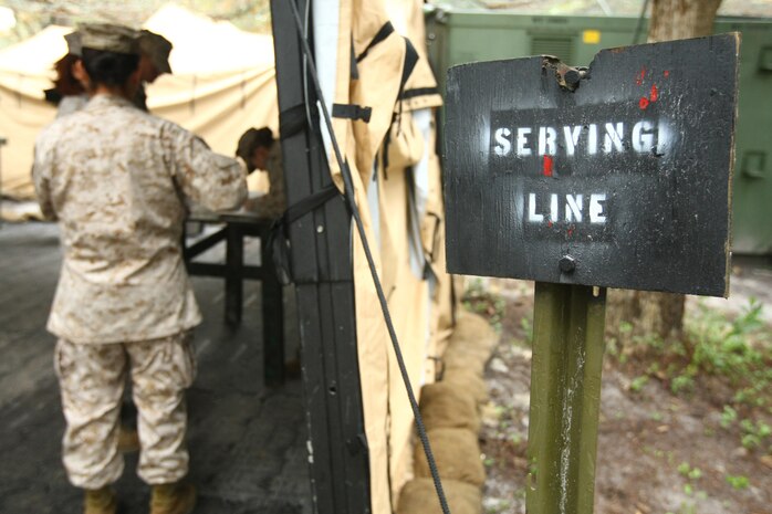 A line of Marines build as they wait for chow at the Combat Logistics Regiment 27 field mess, Camp Yellow Jacket, during their inspections for the Best Marine Corps Mess Hall competition. Every Marine Corps garrison and field mess hall is eligible to enter the competition and possibly win the Maj. Gen. William Pendleton Thompson Hill Award. The competitors must fit within three categories: best military or contractor operated, best all contractor operated and best active field mess. (U.S. Marine Corps photo by Lance Cpl. Damany S. Coleman)