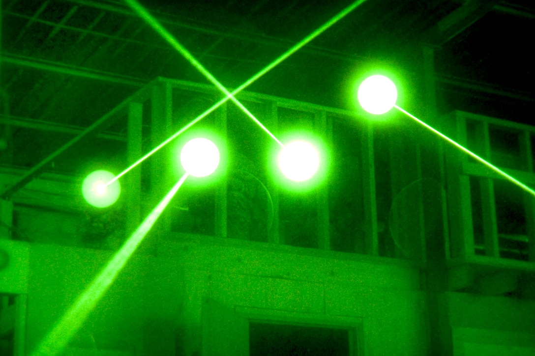 As seen through a night-vision device, U.S. Army paratroopers train using infrared lasers and night-vision optics on Camp Ramadi, Iraq, Oct. 26, 2009.