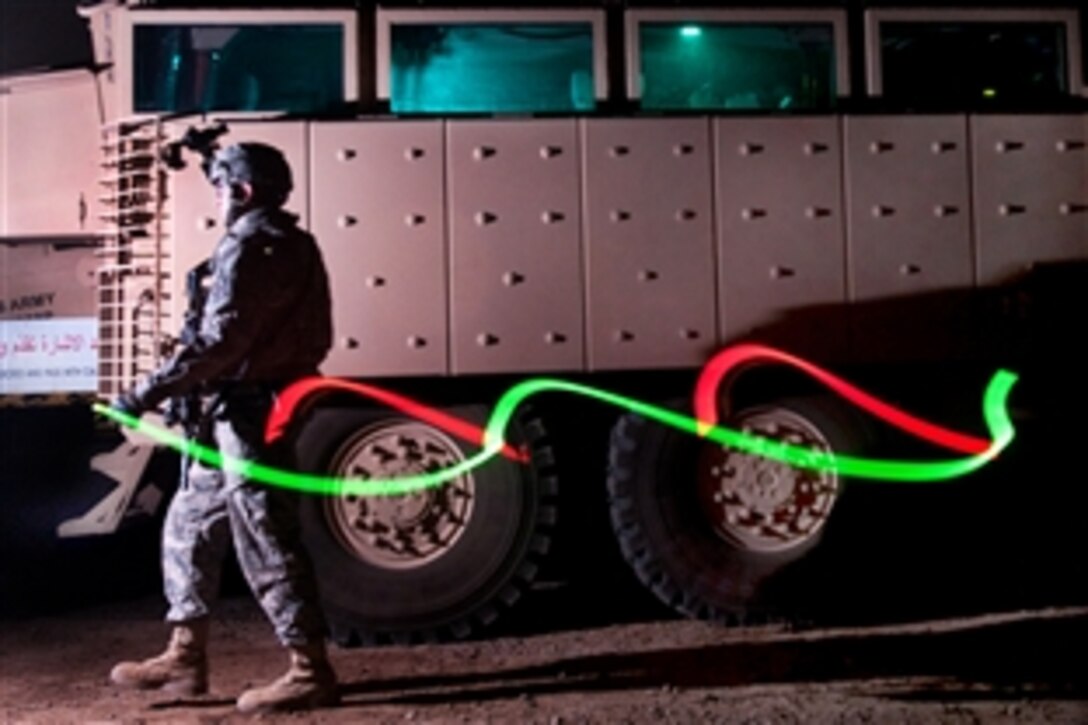 A U.S. Army paratrooper walks with two chemical lights as his unit acts as quick reaction force for Camp Ramadi, Iraq, Oct. 26, 2009. The paratrooper is assigned to the 82nd Airborne Division's Company B, 2nd Battalion, 504th Parachute Infantry Regiment, 1st Brigade Combat Team.
