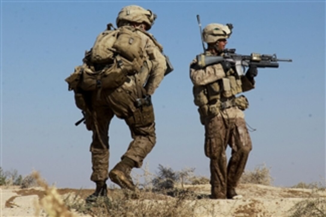 U.S. Marines with Bravo Company, 1st Battalion, 5th Marine Regiment provide security for fellow Marines during a security patrol in the Nawa district of the Helmand province, Afghanistan, on Oct. 20, 2009.  Marines conduct security patrols to decrease insurgent activity and gain the trust of the Afghan people.  The 1st Battalion, 5th Marine Regiment is a combat element of Regimental Combat Team 3, which conducts counterinsurgency operations in partnership with Afghan National Security Forces in southern Afghanistan.  