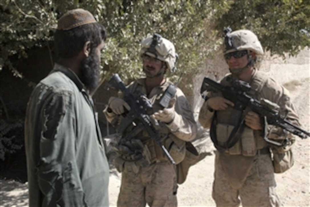 U.S. Marine Corps Sgt. Hugh Styborski and Staff Sgt. Enrique Perez-Arce, both with the 1st Battalion, 5th Marine Regiment, talk with locals in the Nawa district of the Helmand province, Afghanistan, on Oct. 19, 2009.  The 1st Battalion, 5th Marine Regiment is a combat element of Regimental Combat Team 3, which conducts counterinsurgency operations in partnership with Afghan National Security Forces in southern Afghanistan.  