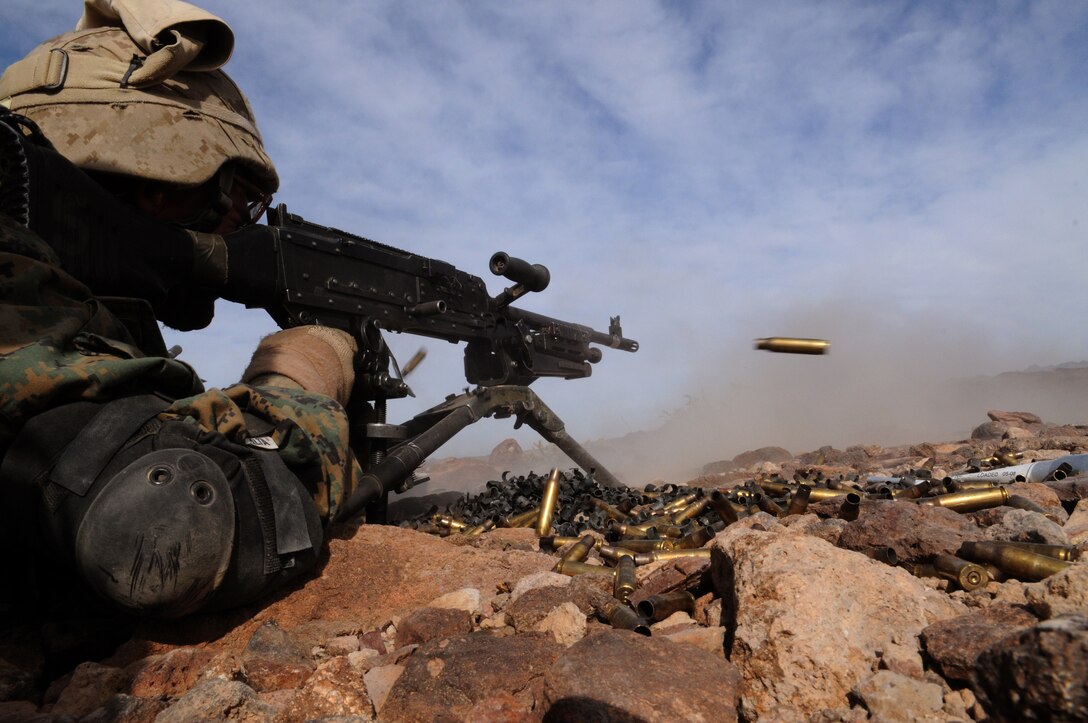 An M-240B machine gun spews spent casings as Pfc. Nathan McBride, a machine gunner with Company C, 1st Battalion, 2nd Marine Regiment, lays down suppressive fire during a company-sized exercise at the U.S. Army Yuma Proving Ground in Arizona, Oct. 27, 2009. The Camp Lejeune, N.C.-based battalion spent approximately one month the Yuma area, making use of its surroundings’ rocky, mountainous terrain in preparation for a deployment to Afghanistan early next year. The exercise stressed the approximately 220-Marine force to use combined arms tactics, ranging from rifles and machine guns to mortars and TOW missiles. McBride, 20, is a Cincinnati-native.
