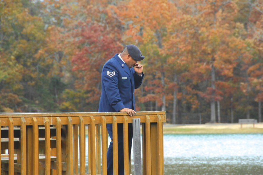 Staff Sgt. Marcus Reaves, handler for military working dog Arras, pays final tribute to his fallen partner. Arras, an explosives detector in the 78th Security Forces Squadron, was killed in the line of duty while deployed to Iraq.  U. S. Air Force photo by Claude Lazzara