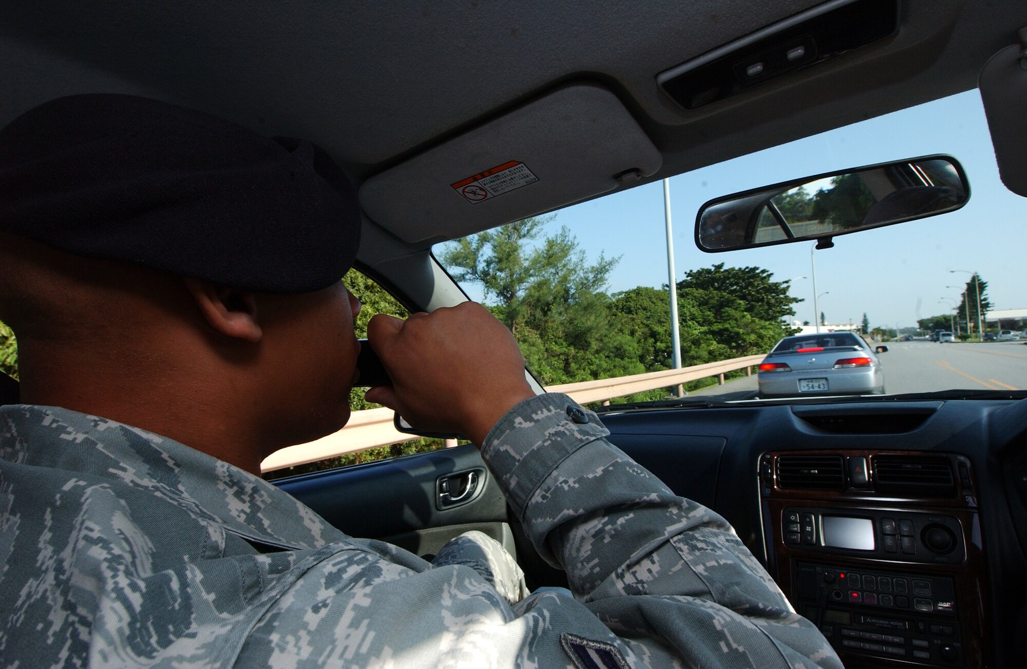 Airman 1st Class Edward Bailey uses a voice speaker to direct a driver to pullover during a traffic stop Oct. 27 at Kadena Air Base, Japan. The Airmen are part of a traffic enforcement team to keep a safe and secure environment for all personnel on the installation.   (U.S. Air Force photo/Tech. Sgt. Rey Ramon)    