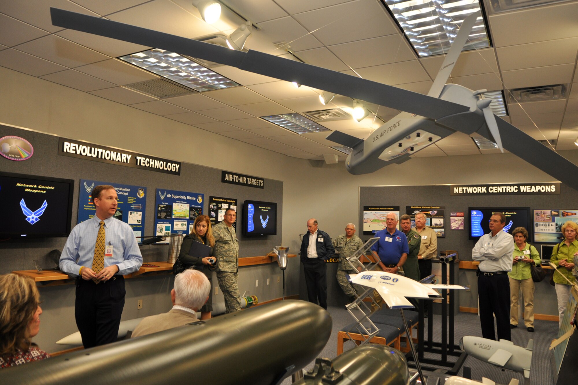 Briefer Brian Mitchell informs a group of civic leaders about past, present and future war technology, in the Taconi Room of the Air Force Research Laboratory Munitions Directorate at Eglin Air Force Base, Fla., October 22, 2009. More than twenty-six influential civic leaders from the Shreveport/Bossier City area of Louisiana gained first-hand knowledge of operations of the Air Force during a two-day “Civic Leader Tour” flight from Barksdale Air Force Base, La., to Eglin on October 21-22, 2009. The leaders received several mission briefings and viewed a static display of the MC-130 Combat Talon I as well as touring several facilities at Eglin AFB and Duke Field, Fla. (U.S. Air Force photo/Tech. Sgt. Jeff Walston)