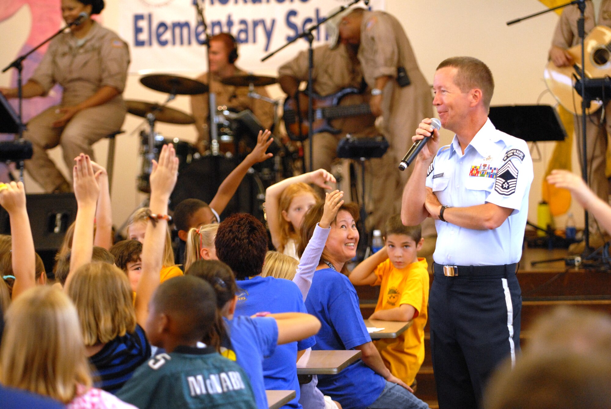 HICKAM AIR FORCE BASE, Hawaii -- Chief Master Sgt. Larry Mactaggart, U.S. Air Force Band of the Pacific band manager, speaks to Mokulele Elementary School students after a performance here Oct. 28. Mokulele, one of two elementary schools on Hickam, was one of six schools the band performed for in support of Red Ribbon Week. Red Ribbon Week focuses on living and maintaining a drug free lifestyle. (U.S. Air Force photo/Senior Airman Gustavo Gonzalez)