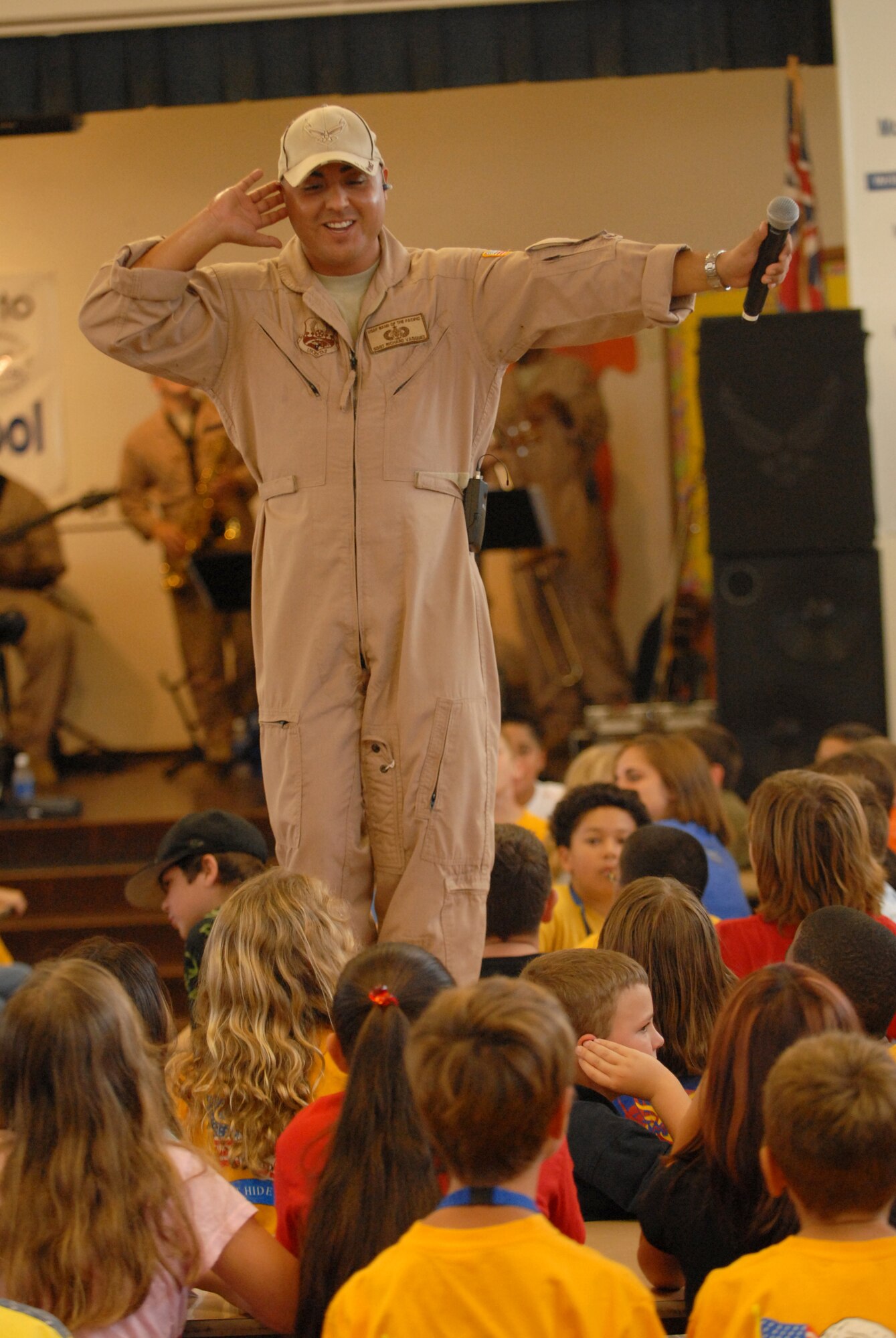 HICKAM AIR FORCE BASE, Hawaii -- Tech. Sgt. Richard Vasquez, U.S. Air Force Band of the Pacific vocalist, interacts with Mokulele Elementary School students during a live music performance here Oct. 28. Mokulele, one of two elementary schools on Hickam, was one of six schools the band performed for in support of Red Ribbon Week. Red Ribbon Week focuses on living and maintaining a drug free lifestyle. (U.S. Air Force photo/Senior Airman Gustavo Gonzalez)