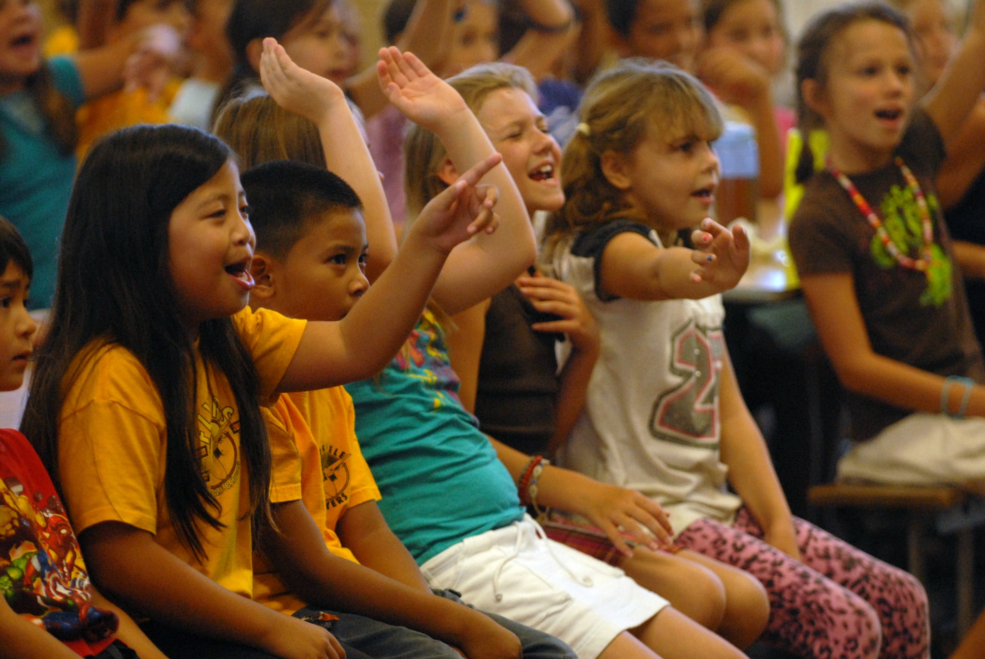 HICKAM AIR FORCE BASE, Hawaii -- Students from Mokulele Elementary School clap their hands and sing along during a performance put on by the U.S. Air Force Band of the Pacific here Oct. 28. Mokulele, one of two elementary schools on Hickam, was one of six schools the band performed for in support of Red Ribbon Week. Red Ribbon Week focuses on living and maintaining a drug free lifestyle. (U.S. Air Force photo/Senior Airman Gustavo Gonzalez)
