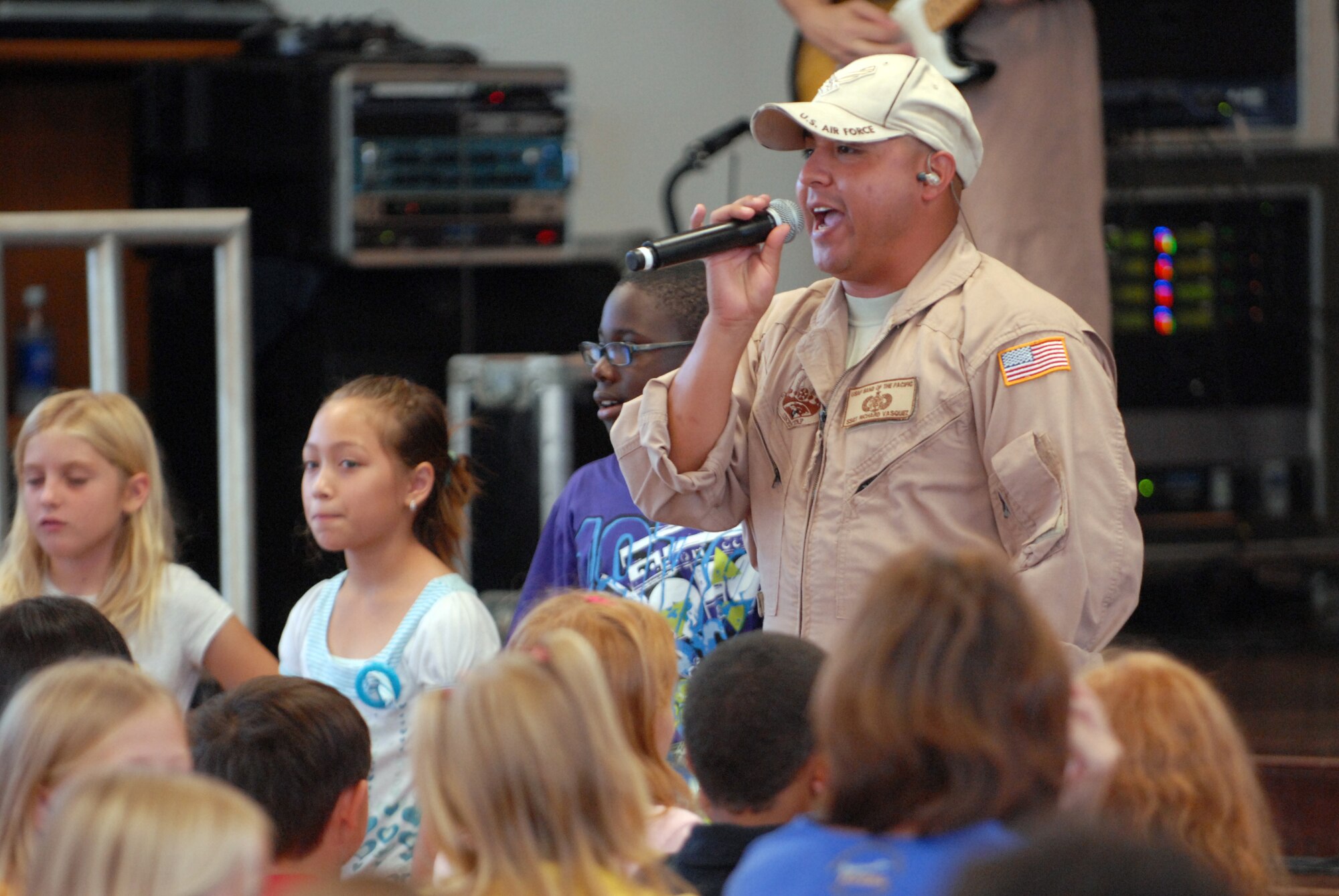 HICKAM AIR FORCE BASE, Hawaii -- Tech. Sgt. Richard Vasquez, U.S. Air Force Band of the Pacific vocalist, sings during the bands performance at Mokulele Elementary School here Oct. 28. Mokulele, one of two elementary schools on Hickam, was one of six schools the band performed for in support of Red Ribbon Week. Red Ribbon Week focuses on living and maintaining a drug free lifestyle. (U.S. Air Force photo/Senior Airman Gustavo Gonzalez)