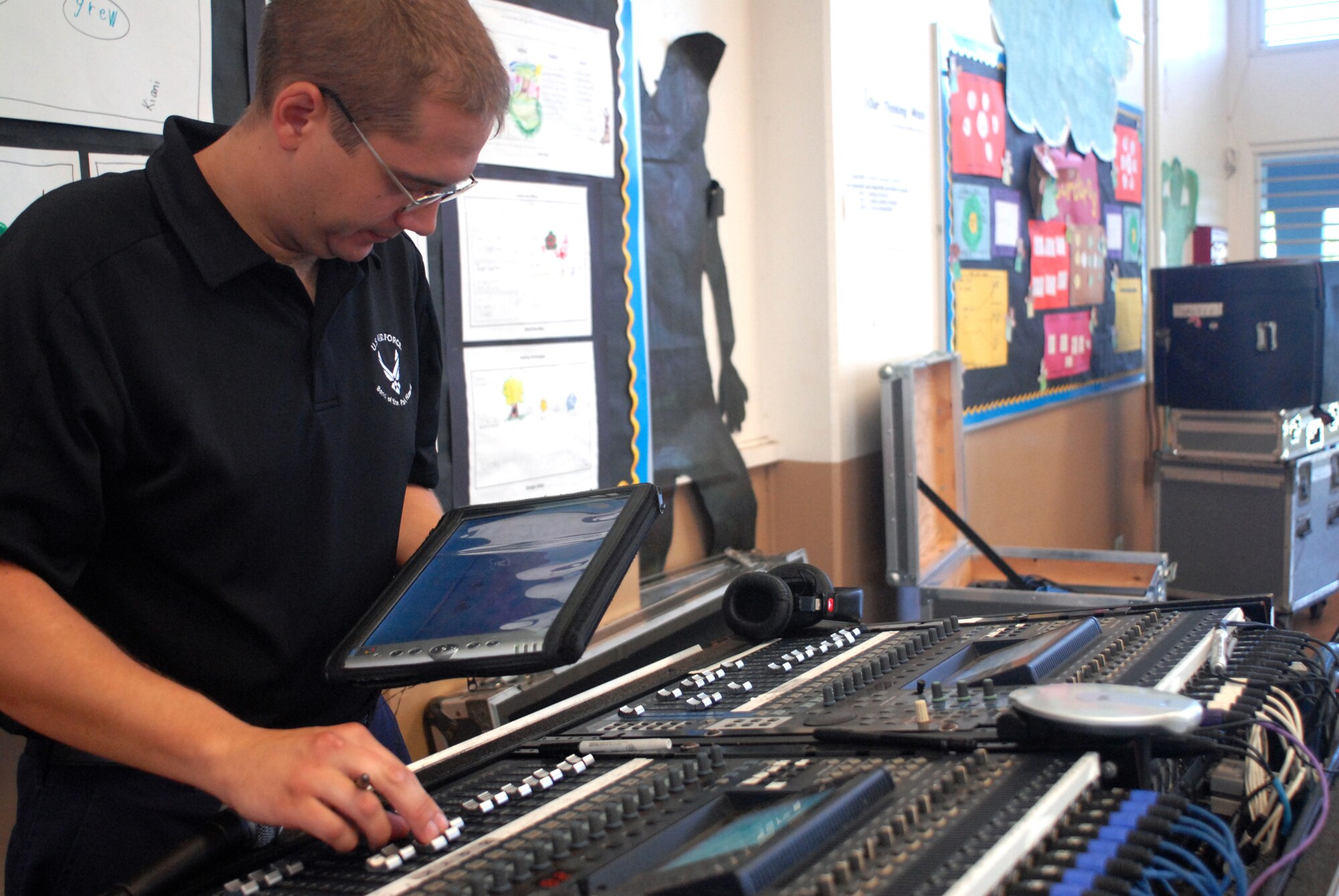 HICKAM AIR FORCE BASE, Hawaii -- Tech. Sgt. Steven Dengler, U.S. Air Force Band of the Pacific sound technician, pre sets the settings on an audio mixer before performing at Mokulele Elementary School here Oct. 28. Mokulele, one of two elementary schools on Hickam, was one of six schools the band performed for in support of Red Ribbon Week. Red Ribbon Week focuses on living and maintaining a drug free lifestyle. (U.S. Air Force photo/Senior Airman Gustavo Gonzalez)