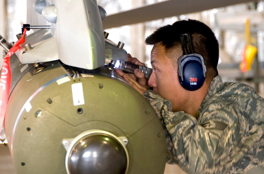 MISAWA AIR BASE, Japan -- Staff Sgt. David Hsu, 14th Aircraft Maintenance Unit weapons specialist, inspects munitions on an F-16 Fighting Falcon during the weapons load-crew competition Oct. 23. Weapons specialists are responsible for all munitions loaded on the aircraft. (U.S. Air Force photo/Staff Sgt. Chad C. Strohmeyer)