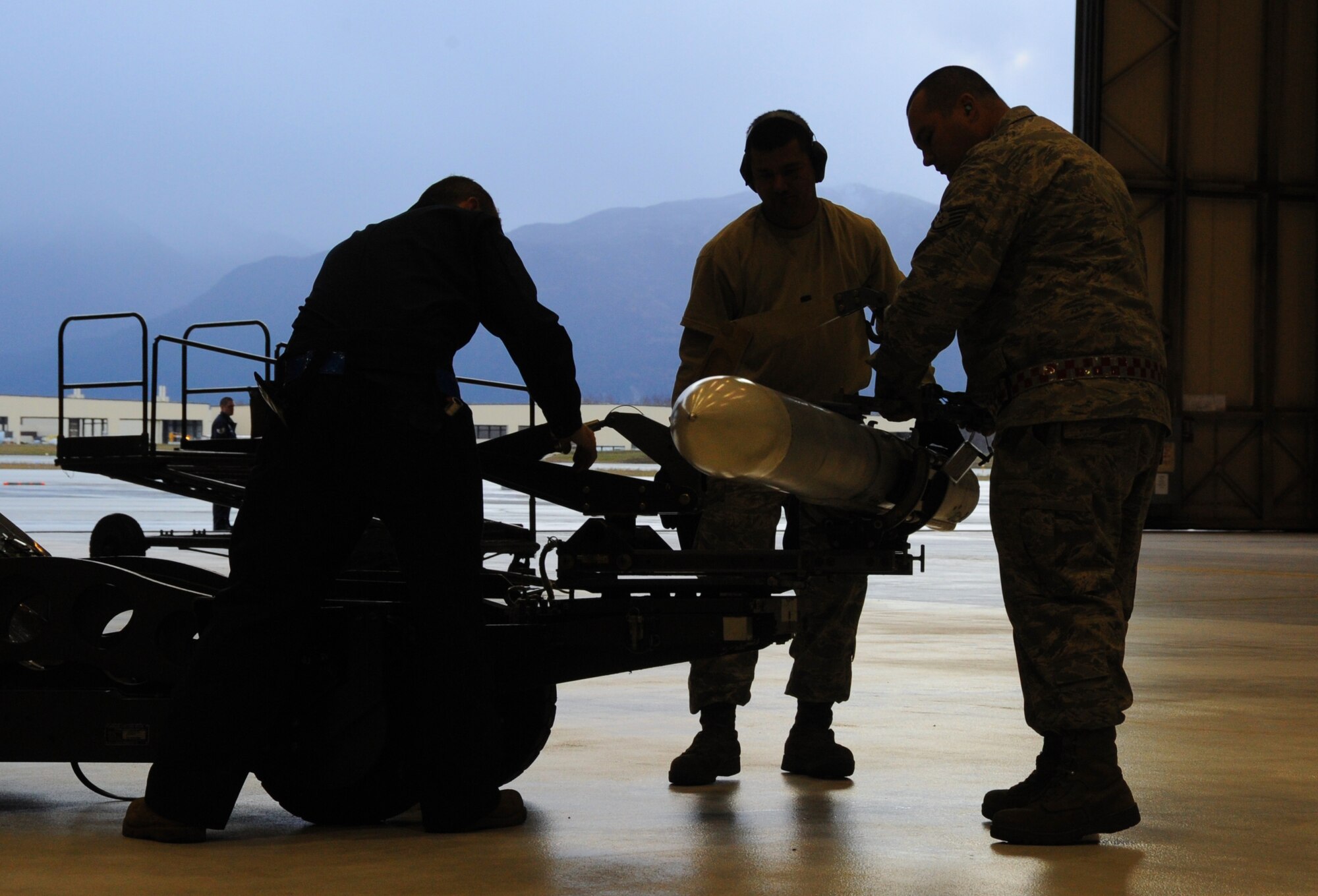 ELMENDORF AIR FORCE BASE, Alaska -- Staff Sgt. Randy DaSilva shows how to secure an air intercept missile 120 on the missile cradle during missile loading certification Oct. 23. Airmen must be certified on all missile loading procedures once a month. DaSilva is a squadron lead crew team chief for the 3rd Mission Operations Squadron. (U.S. Air Force photo/Senior Airman Cynthia Spalding)