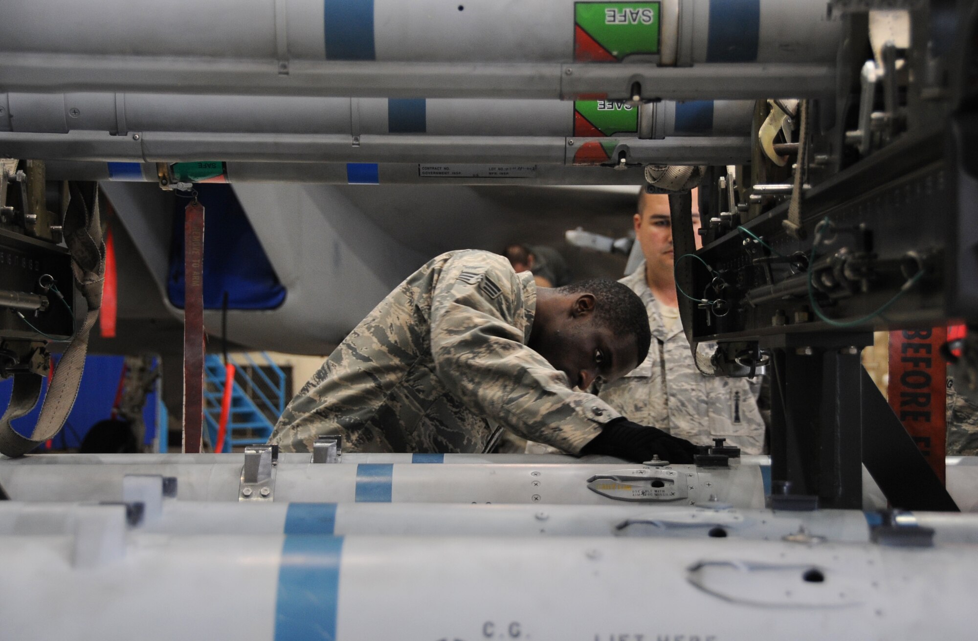 ELMENDORF AIR FORCE BASE, Alaska -- Senior Airman Mitch Mitchell inspects missiles prior to loading them on an F-15 during certification Oct. 20. Airmen must be certified on missile loading once a month. Mitchell is an aircraft armament systems specialist with the 19th Aircraft Maintenance Unit. (U.S. Air Force photo/Senior Airman Cynthia Spalding)