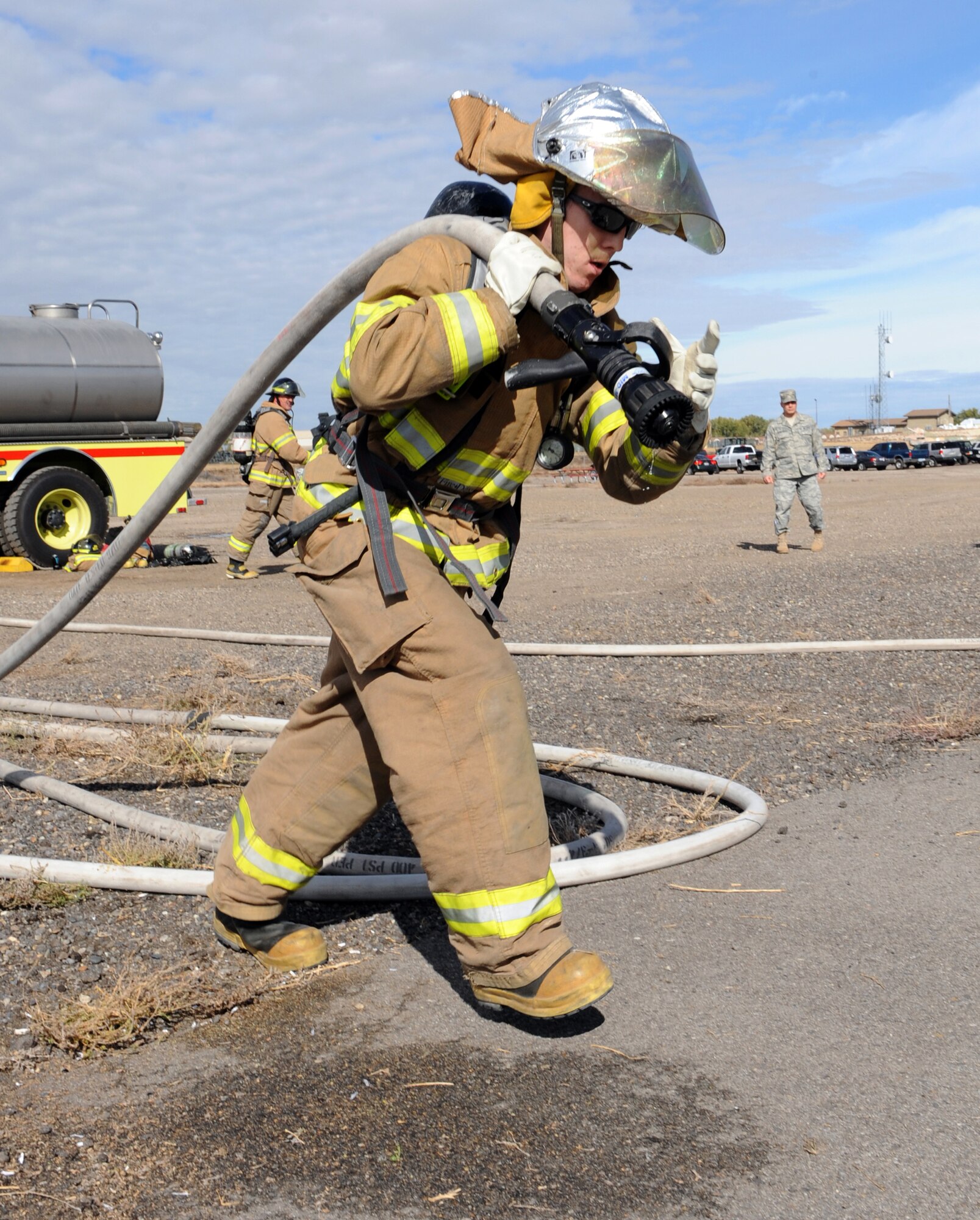 MOUNTAIN HOME AIR FORCE BASE, Idaho -- Staff Sgt. Jacob Casey, 366th Force Support Squadron team member, pulls a fire hose 100 feet as part of the first annual Fire Muster Challenge Oct. 23. Six teams competed in the timed challenge that consisted of five events. 366th Logistics Readiness Squadron team came in first place with a time of 2:53, 366th Civil Engineer Squadron explosive ordnance disposal came in second with a time of 3:18 and in third place was the senior noncommissioned officers with a time of 3:31. The fire department ultimately won the championship round with a time of 2:38. (U.S. Air Force photo by Airman 1st Class Debbie Lockhart)
