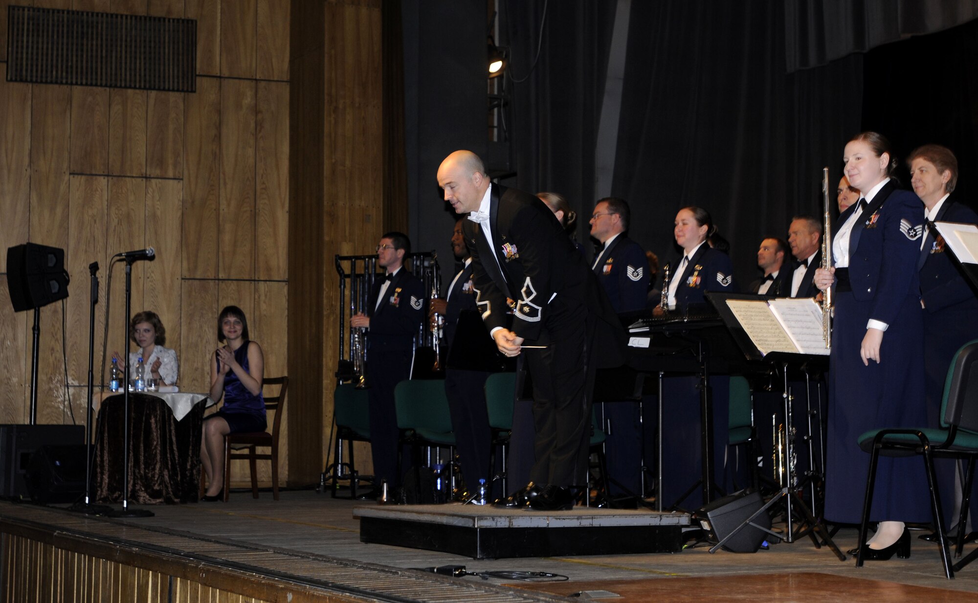 KUTNO, Poland – Maj. Matt Henry, U.S. Air Forces in Europe Band’s commander and musical director, takes a bow along with the concert band Oct. 24 during their performance at the Kutno Cultural Center.  The band is performing six concerts in six days, Oct. 20-25, in support of USAFE's international relations program in partnership with the U.S. State Department.  Four hundred people from Kutno attended this concert which commemorates 90 years of diplomatic relations between the United States and Poland.  (U.S. Air Force photo/Master Sgt. Kelley J. Stewart)