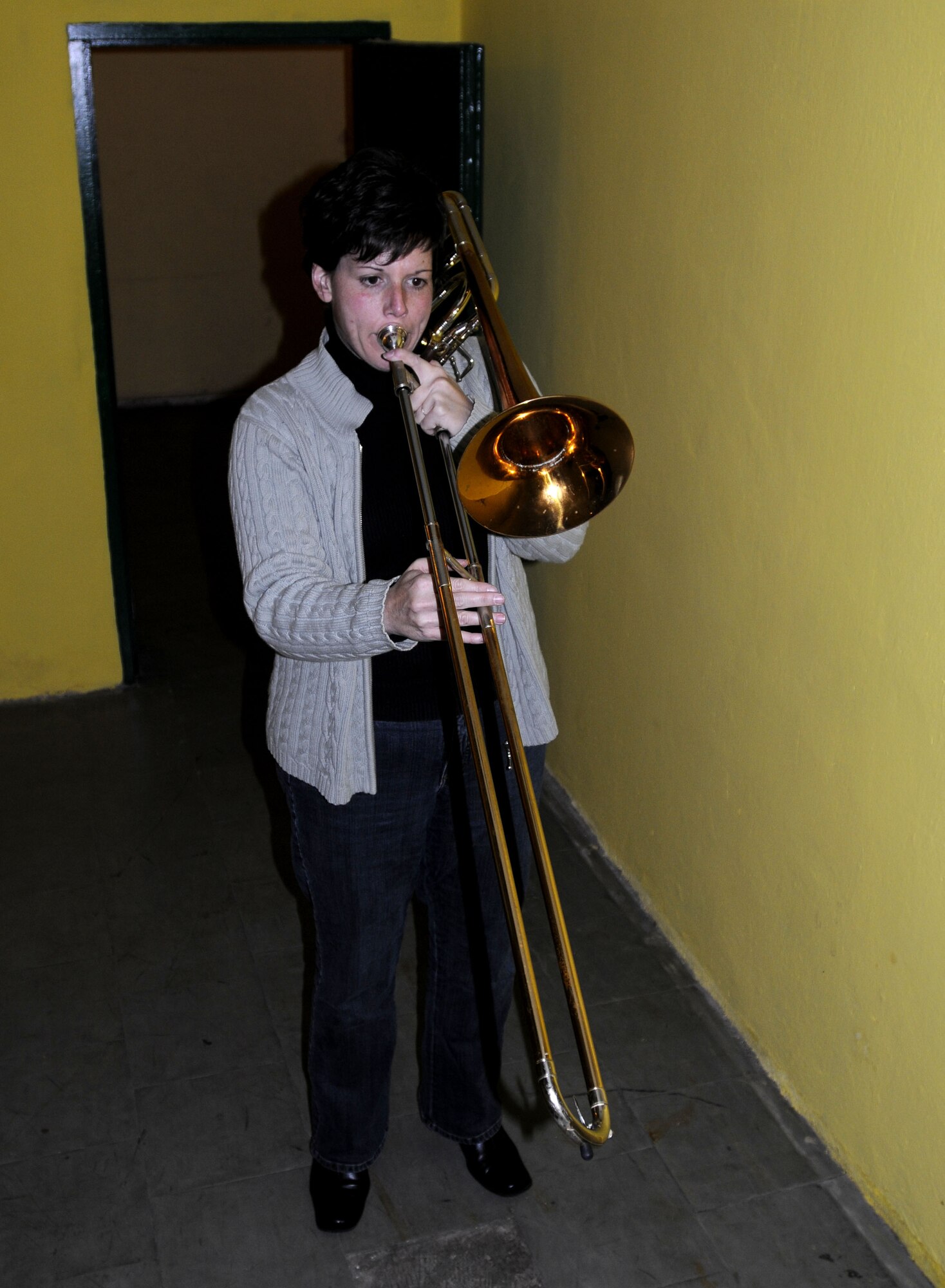 KUTNO, Poland – Staff Sgt. Saundra Sininger warms on the trombone before performing at the Kutno Cultural Center here Oct. 24 prior to the U.S. Air Forces in Europe Band’s concert.  The USAFE Band is performing six concerts in six days, Oct. 20-25, in support of USAFE's international relations program in partnership with the U.S. State Department.  Four hundred people from Kutno attended this concert which commemorates 90 years of diplomatic relations between the United States and Poland.  (U.S. Air Force photo/Master Sgt. Kelley J. Stewart)