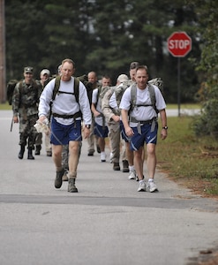 Col. John Wood, right, and Col. Benjamin Wham and lead 437th Civil Engineer Squadron Explosive Ordnance Disposal Flight members on a ruck march here Oct. 27. The EOD personnel train with ruck sacks to prepare for embedding with sister services and foreign special forces in a dismounted capacity while deployed. Colonel Wood is the 437th Airlift Wing commander and Colonel Wham is the 437th Mission Support Group commander. (U.S. Air Force photo/James Bowman)