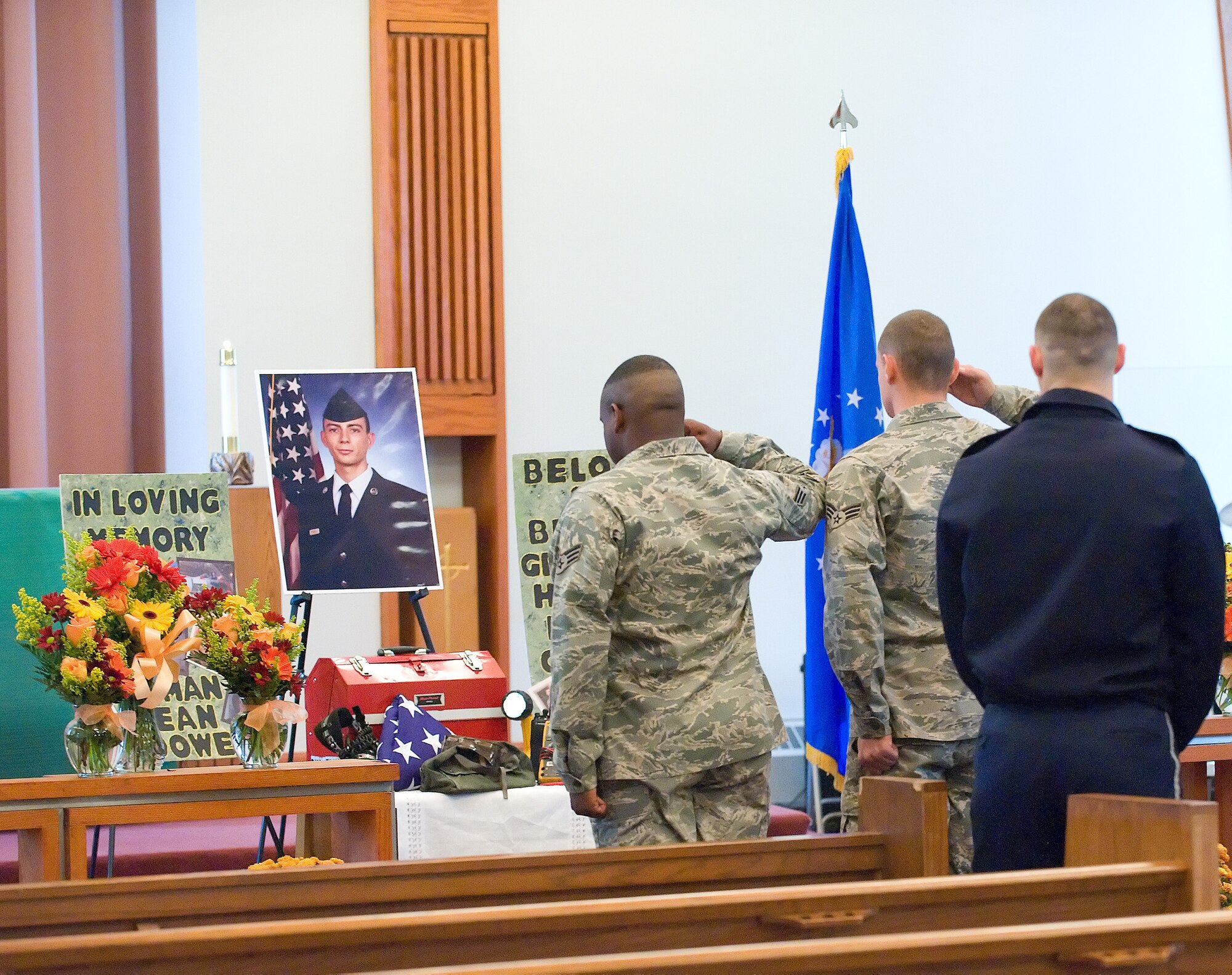 Two Airmen say a final goodbye to Airman Sean M. McDowell following a memorial service in the Carpenter Chapel Oct. 22. (U.S. Air Force photo/Jason Minto)