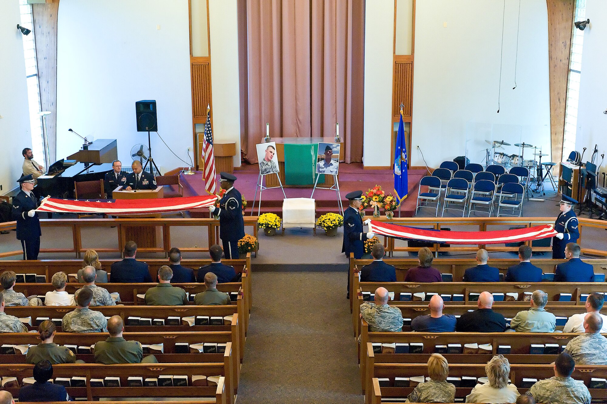 The Dover Air Force Base Honor Guard perform a flag-folding ceremony during the memorial service for Airman 1st Class Darrick A. Wright, 19, a native of Garfield, Ind., Oct. 22. Airman Wright was a Pavements and Construction Equipment apprentice assigned to the 436th Civil Engineer Squadron. (U.S. Air Force photo/Roland Balik)