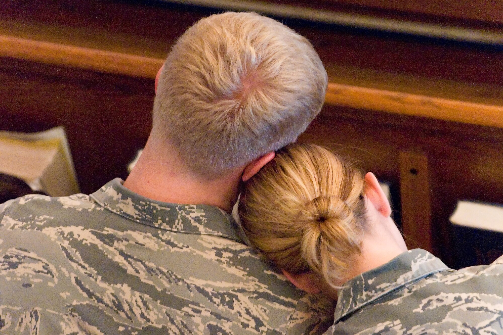 Two Dover Airmen support each other during a memorial service Oct. 22 at the Carpenter Chapel here. Memorial services were held to remember Airman 1st Class Darrick A. Wright, 19, a native of Garfield, Ind., and Airman Sean M. McDowell, 24, a native of Covina, Calif., who died Oct. 18. (U.S. Air Force photo/Roland Balik)