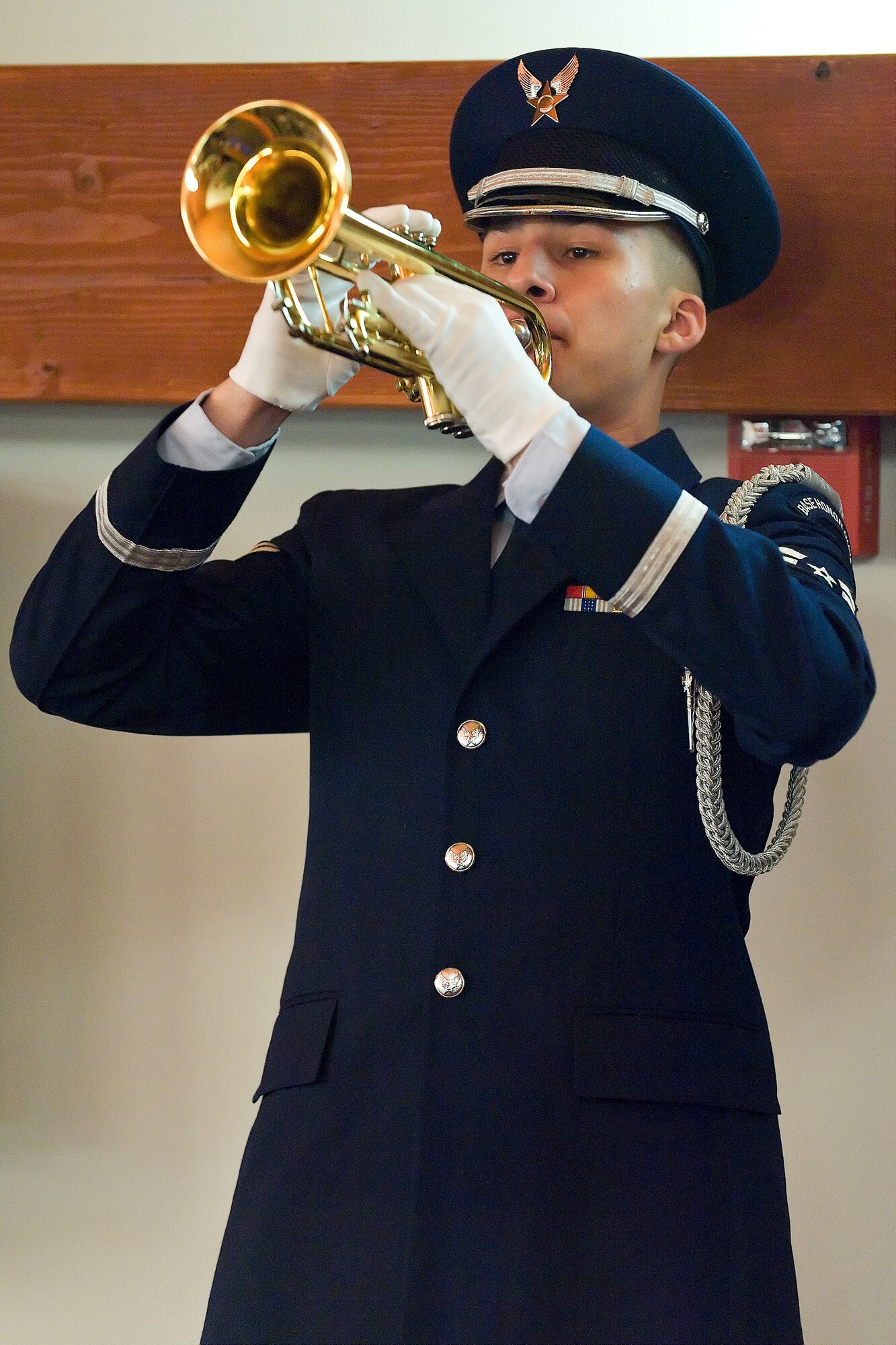 Airman 1st Class Dustin Trevino, Dover Air Force Base Honor Guard, performs Taps during a memorial service Oct. 22 at the Carpenter Chapel here. Team Dover held memorial services for Two Airmen who died in a vehicle accident Oct. 18. (U.S. Air Force photo/Roland Balik)
