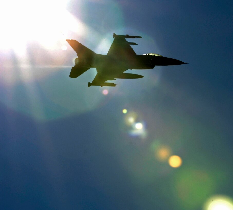 LANGLEY AIR FORCE BASE, Va. – An F-16C Fighting Falcon piloted by Maj. John Wilcox, Air Combat Command Inspector General F-16 Operations inspector, is shown silhouetted against the sun during takeoff here Oct. 28. The fighter jet carries a fourth generation advanced targeting LITENING pod, this is the first test during a two week exercise called Bold Quest 2009, an advanced concept technology demonstration.(U.S. Air Force photo/Airman Rebecca Montez)