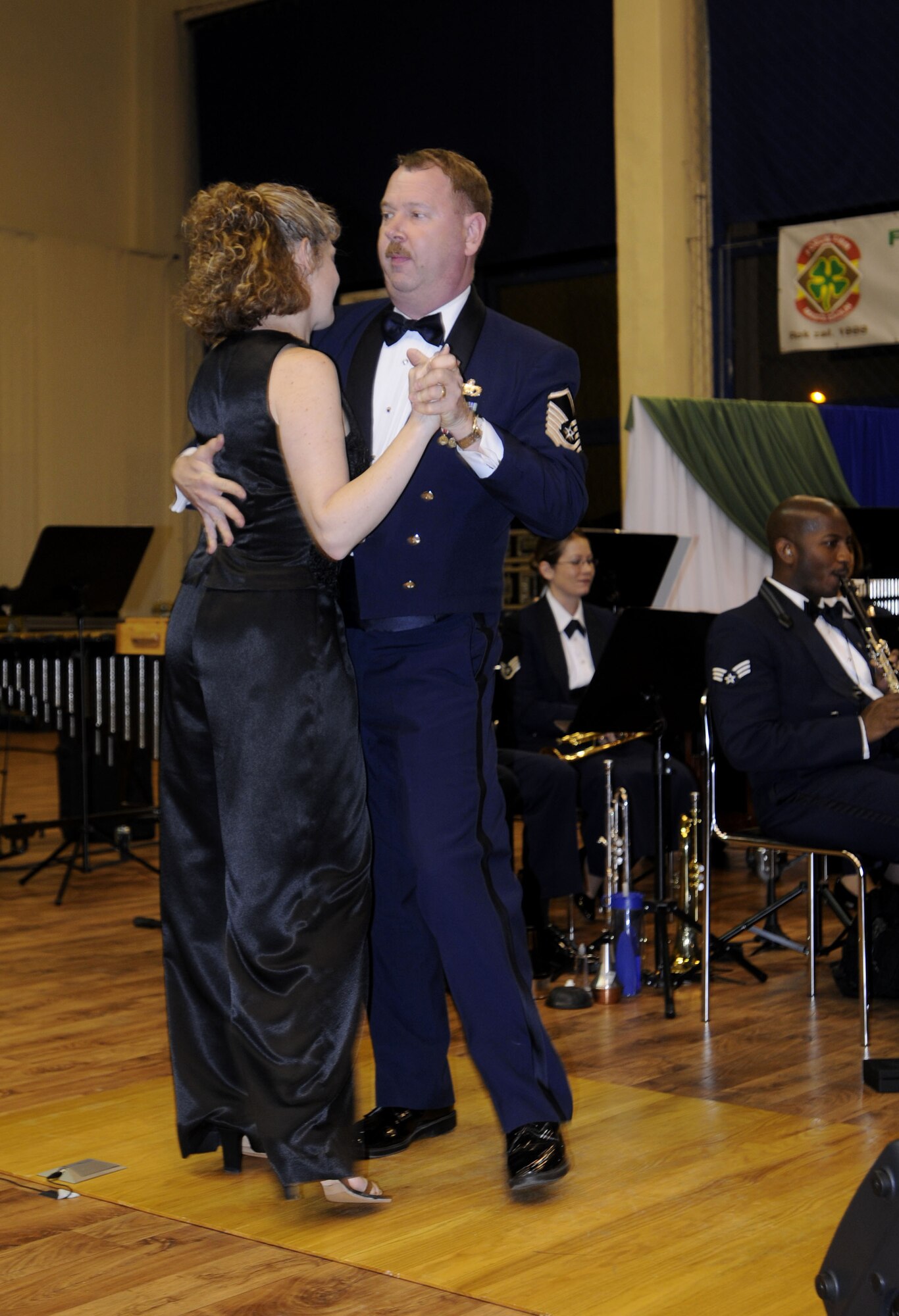 RADLIN, Poland – Master Sgt. James Bartelt, percussionist, and Tech. Sgt. Amy Lukens-Malone, vocalist, dance during Senior Airman Rachel Trimble’s performance of “Cheek to Cheek” at the Radlin City Center of Sports and Recreation here Oct. 23.  The USAFE Band is performing six concerts in six days, Oct. 20-25, in support of USAFE's international relations program in partnership with the U.S. State Department.  Four hundred people from Radlin attended this concert which commemorates 90 years of diplomatic relations between the United States and Poland.  (U.S. Air Force photo/Master Sgt. Kelley J. Stewart)