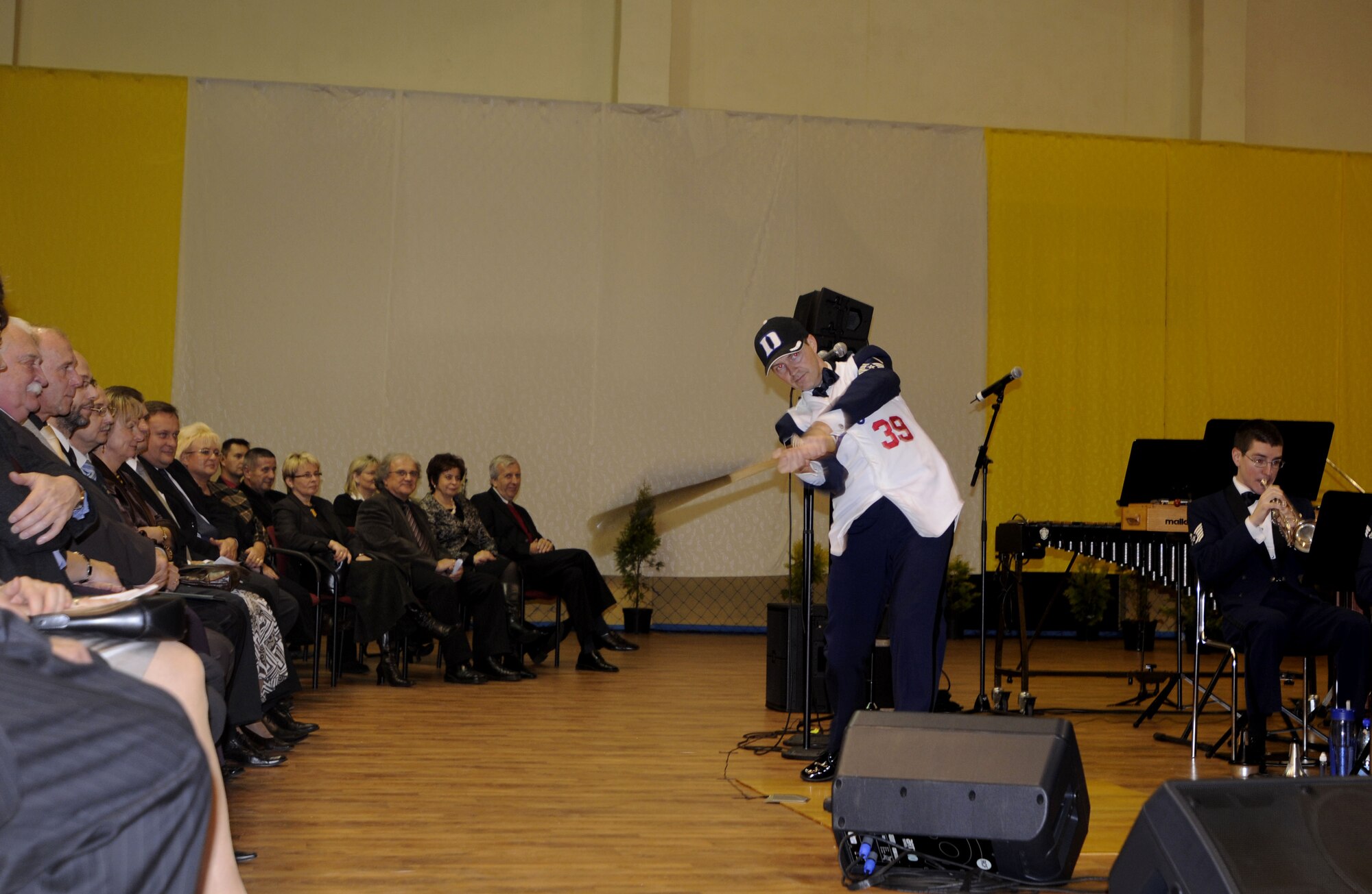 RADLIN, Poland – Master Sgt. Charles Anderson, trombonist, swing a baseball bat during the U.S. Air Forces in Europe Band’s performance of “The National Game March” at the Radlin City Center of Sports and Recreation here Oct. 23.  The USAFE Band is performing six concerts in six days, Oct. 20-25, in support of USAFE's international relations program in partnership with the U.S. State Department.  Four hundred people from Radlin attended this concert which commemorates 90 years of diplomatic relations between the United States and Poland.  (U.S. Air Force photo/Master Sgt. Kelley J. Stewart)