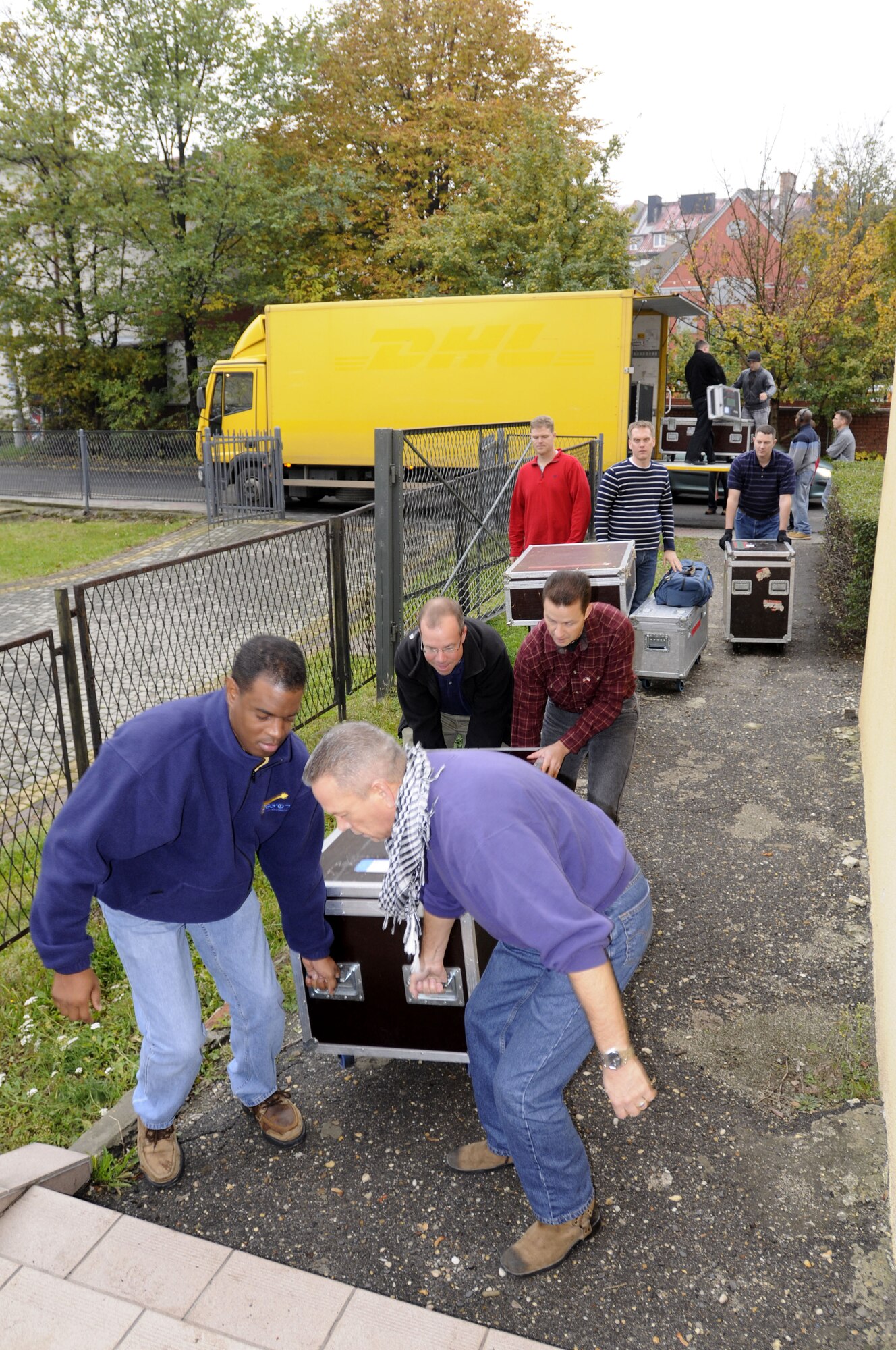 RADLIN, Poland – Members of the U.S. Air Forces in Europe Band unload one of two trucks traveling with the group on their Poland tour at the Radlin City Center of Sports and Recreation Oct. 23.  The USAFE Band sets up and tears downs before and after each performance.  The band is performing six concerts in six days, Oct. 20-25, in support of Gen. Roger Brady’s, USAFE commander, international relations program in partnership with the U.S. State Department.  Four hundred people from Radlin attended this concert which commemorates 90 years of diplomatic relations between the United States and Poland.  (U.S. Air Force photo/Master Sgt. Kelley J. Stewart)