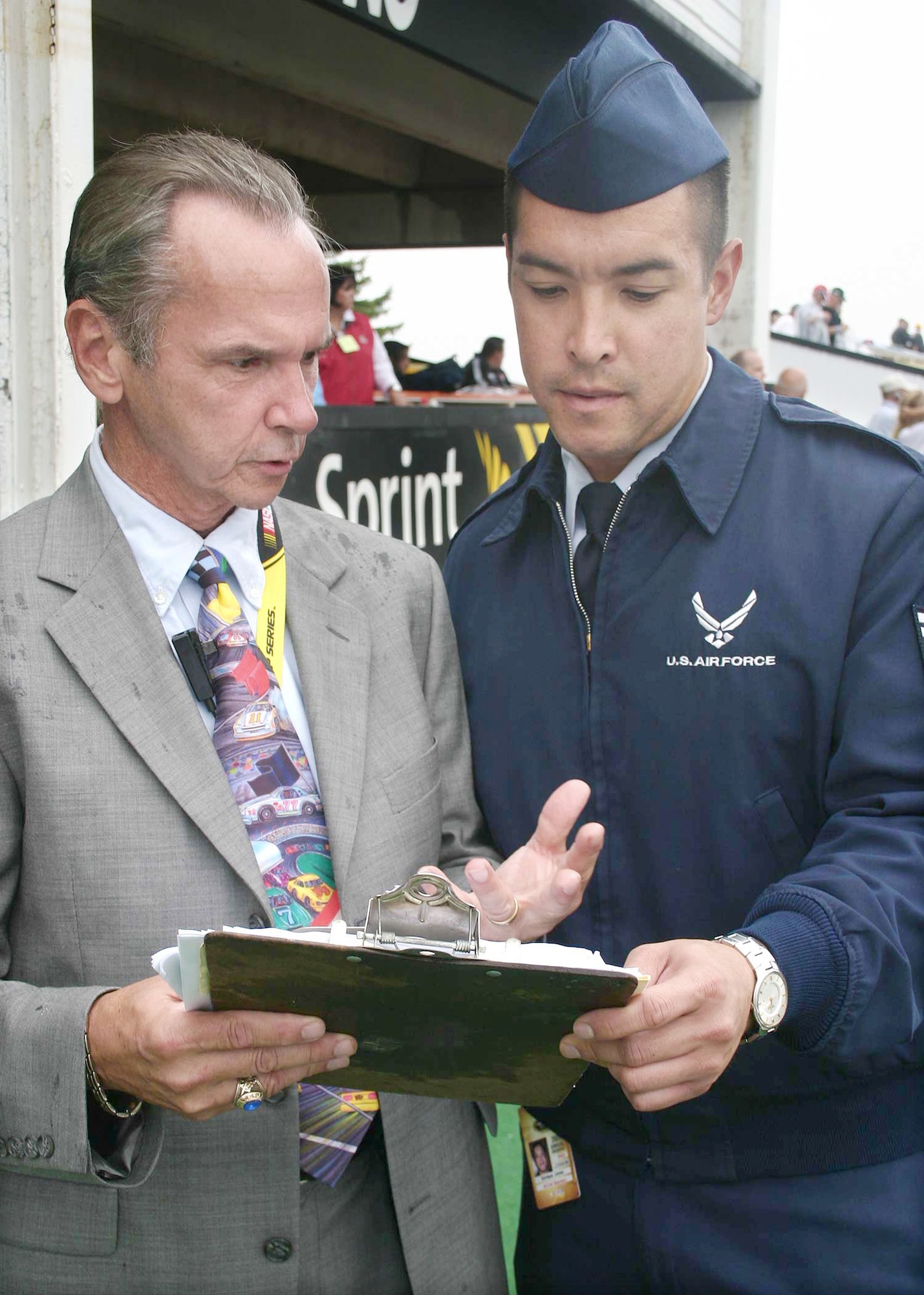 Bob Pallo, Pocono Raceway vice president and Tech. Sgt. Rick Jones finalize last-minute details for the pre-race festivities at the Pennsylvania 500 race earlier this year. Sergeant Jones is the NCO in charge of the Air Force NASCAR program. (U.S. Air Force photo/Dale Eckroth) 
