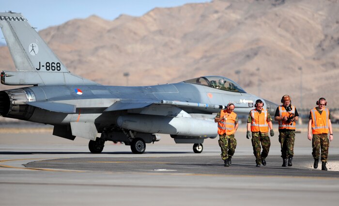 NELLIS AIR FORCE BASE, Nev. -- Royal Netherlands Air Force Crew Chiefs walk away from one of the Netherlands F-16AM Fighting Falcons after completing a final pre-flight check at the end of the runway before a training mission at Red Flag 10-1, Oct. 22, 2009. Red Flag is a realistic combat training exercise involving the air forces of the United States and its allies. The exercise is conducted on the 15,000-square-mile Nevada Test and Training Range, north of Las Vegas. (U.S. Air Force photo by Airman 1st Class Brett Clashman)(Released)