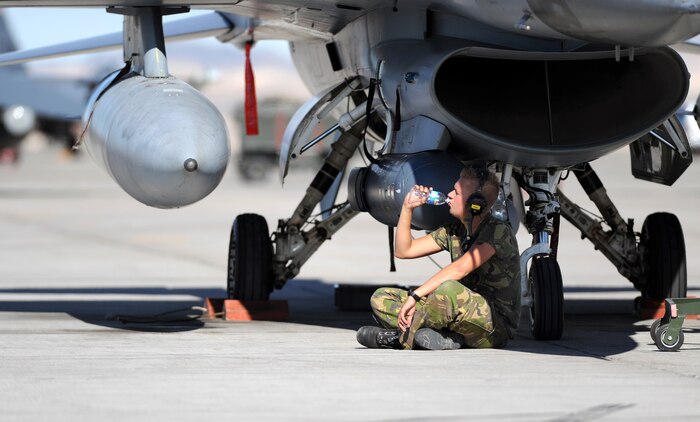 NELLIS AIR FORCE BASE, Nev. --  Sgt. Halbe Bremer, an F-16 crew chief assigned to The Royal Netherlands Air Force, drinks a bottle of water at Red Flag 10-1, Oct. 22, 2009. Staying hydrated is important when working in high temperature areas. Red Flag is a realistic combat training exercise involving the air forces of the United States and its allies. The exercise is conducted on the 15,000-square-mile Nevada Test and Training Range, north of Las Vegas. (U.S. Air Force photo by Airman 1st Class Brett Clashman)(Released)