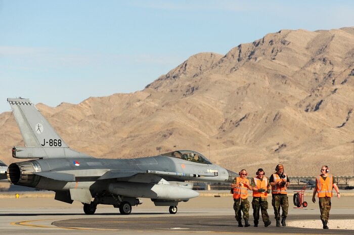 NELLIS AIR FORCE BASE, Nev. --  Royal Netherlands Air Force Crew Chiefs walk away from one of the Netherlands F-16AM Fighting Falcons after completing a final pre-flight check at the end of the runway before a training mission at Red Flag 10-1.  Red Flag is a realistic combat training exercise involving the air forces of the United States and its allies. The exercise is conducted on the 15,000-square-mile Nevada Test and Training Range, north of Las Vegas. (U.S. Air Force photo by Tech. Sgt. Michael R. Holzworth)(Released)