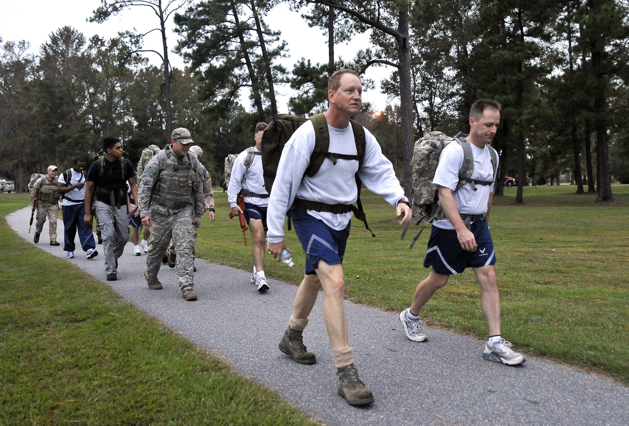 Col. John Wood, right, and Col. Benjamin Wham lead 437th Civil Engineer Squadron Explosive Ordnance Disposal Flight members on a ruck march here Oct. 27. The EOD personnel train with ruck sacks to prepare for embedding with sister services and foreign special forces in a dismounted capacity while deployed. Colonel Wood is the 437th Airlift Wing commander and Colonel Wham is the 437th Mission Support Group commander. (U.S. Air Force photo/James Bowman)
