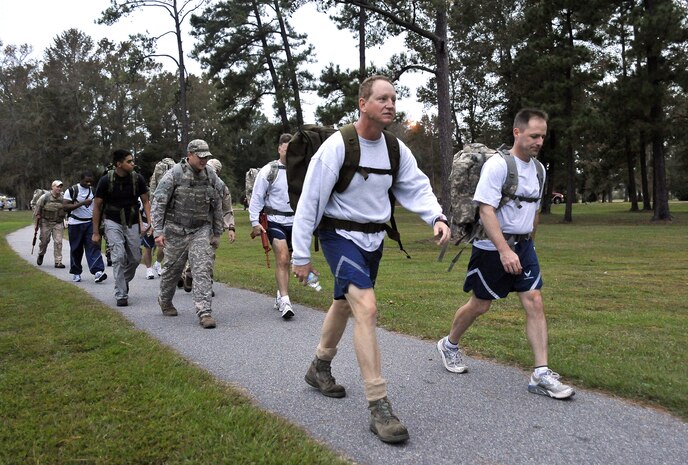 Col. John Wood, right, and Col. Benjamin Wham lead 437th Civil Engineer Squadron Explosive Ordnance Disposal Flight members on a ruck march here Oct. 27. The EOD personnel train with ruck sacks to prepare for embedding with sister services and foreign special forces in a dismounted capacity while deployed. Colonel Wood is the 437th Airlift Wing commander and Colonel Wham is the 437th Mission Support Group commander. (U.S. Air Force photo/James Bowman)
