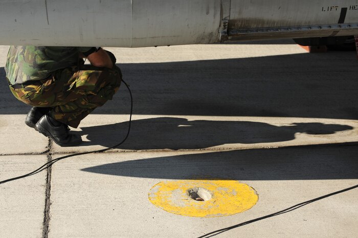 NELLIS AIR FORCE BASE, Nev. -- 1st Sgt. Eerde Adema a crew chief from the Royal Netherlands Air Force crouches down near an F-16AM as he completes pre-flight checks with Royal Netherlands Pilot 1st Lt. Valks Arend before a training mission at Red Flag 10-1.  Red Flag is a realistic combat training exercise involving the air forces of the United States and its allies. The exercise is conducted on the 15,000-square-mile Nevada Test and Training Range, north of Las Vegas. (U.S. Air Force photo by Tech. Sgt. Michael R. Holzworth)(Released)