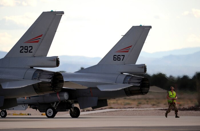 NELLIS AIR FORCE BASE, Nev. -- Cpl. Christian Dag, A Crew Chief from The Royal Norwegian Air Force, performs a pre-launch check on F-16AM's at Red Flag 10-1, Oct. 20, 2009. Red Flag is a realistic combat training exercise involving the air forces of the United States and its allies. The exercise is conducted on the 15,000-square-mile Nevada Test and Training Range, north of Las Vegas. (U.S. Air Force photo by Airman 1st Class Brett Clashman)(Released)