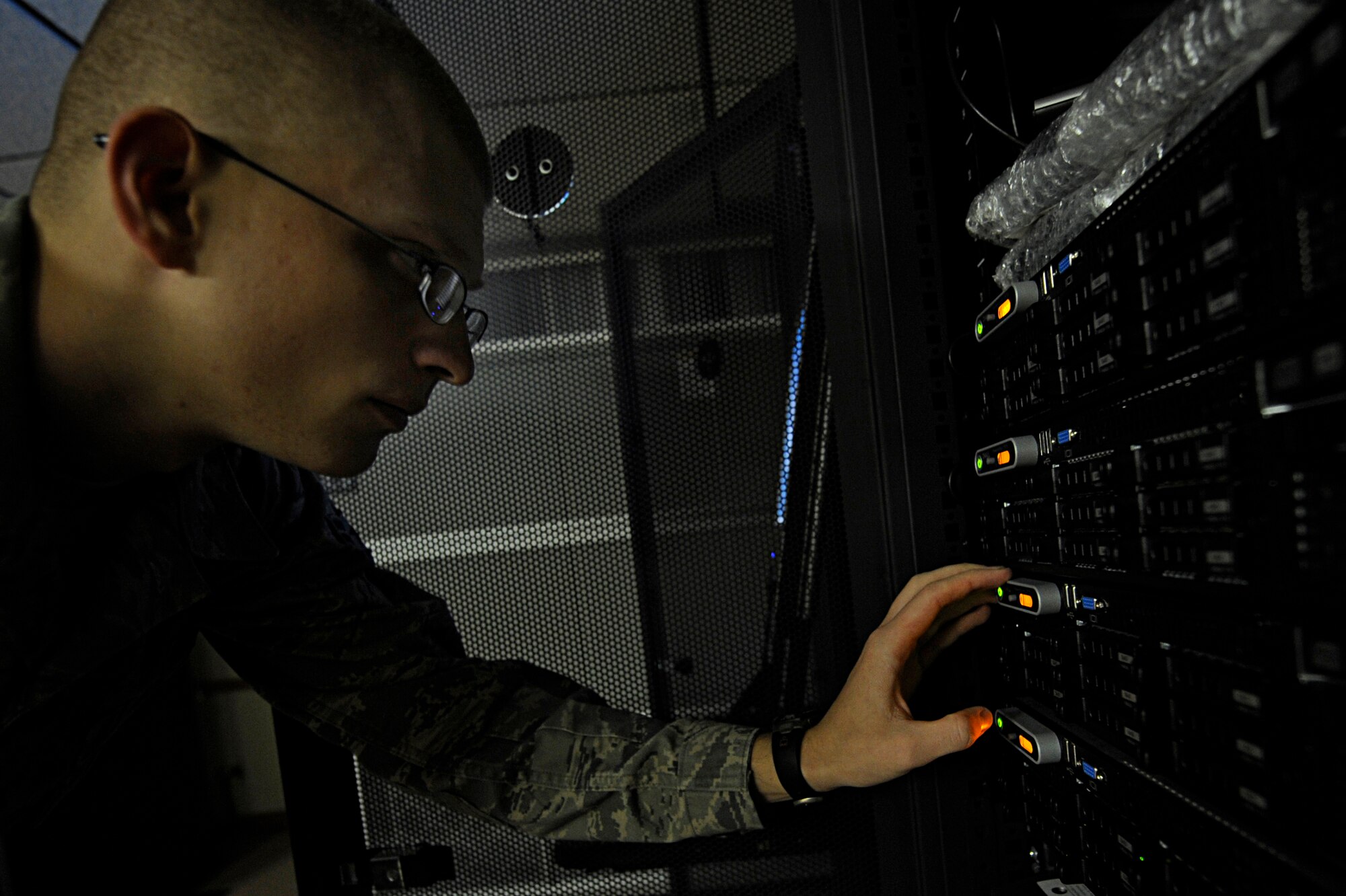 Airman 1st Class Paul DeJarnette, 28th Communications Squadron network control center technician, examines system information on a server here, Oct. 27. The NCC troubleshoots network problems and provides account support for customers. (U.S. Air Force photo/Airman 1st Class Matthew Flynn)