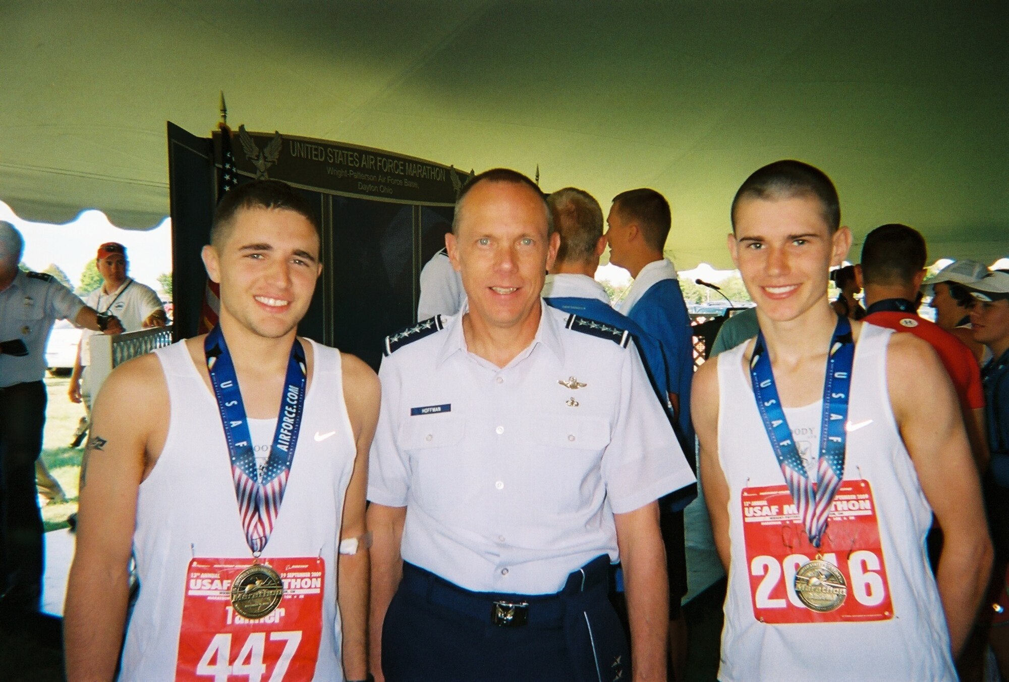 WRIGHT-PATTERSON AIR FORCE BASE, Ohio -- Airmen 1st Class Tanner Bryan and Anton Shevchenko, Moody's Air Force Marathon Team members, take a photo with General Donald Hoffman, Air Force Materiel Command. (Courtesy photo)