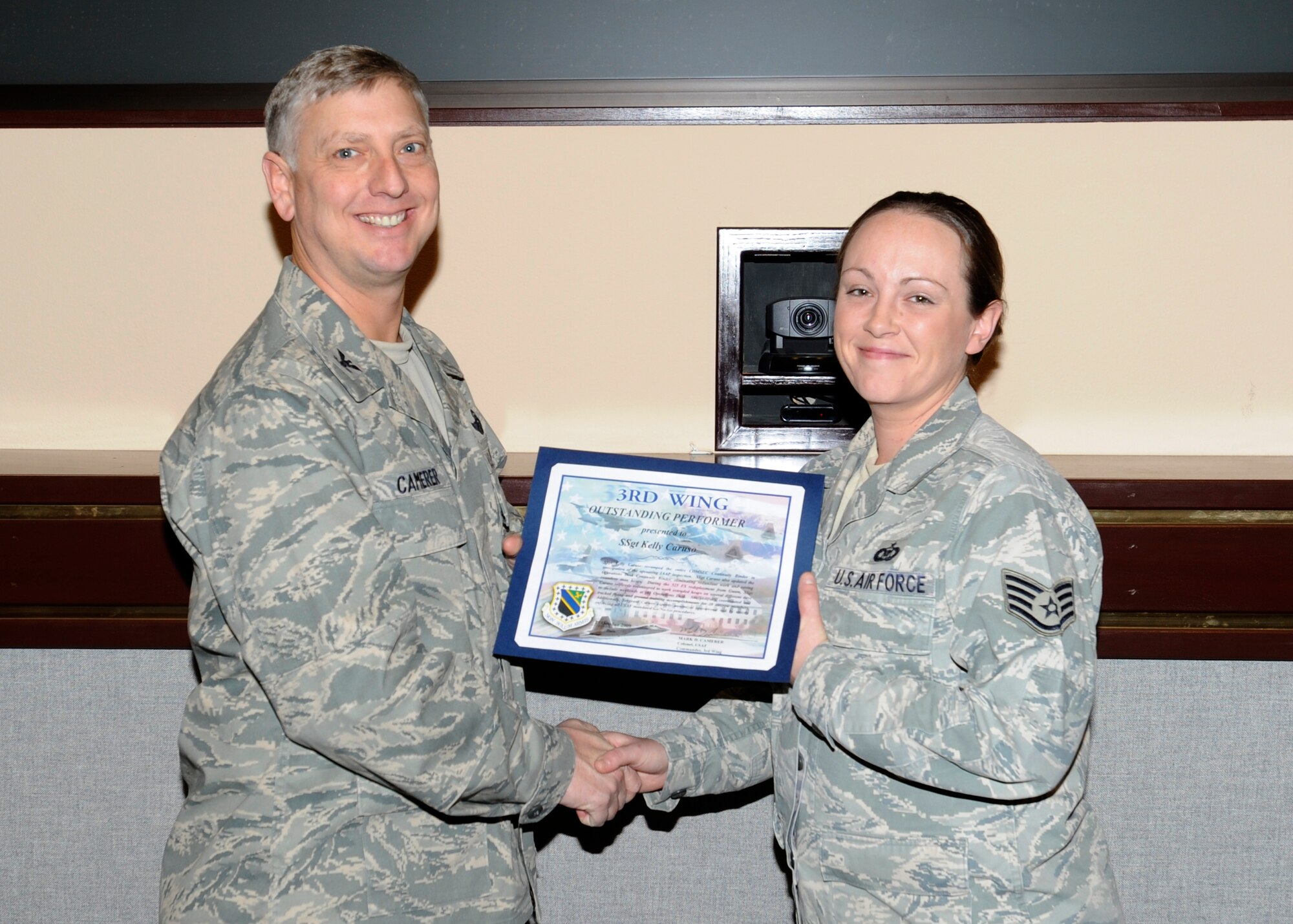 ELMENDORF AIR FORCE BASE, Alaska -- Staff Sgt. Kelly Caruso, 525th Fighter Squadron, receives the 3rd Wing outstanding performer award from Col. Mark Camerer, 3rd Wing vice commander. (U.S. Air Force photo/Senior Airman Matt Coleman-Foster)