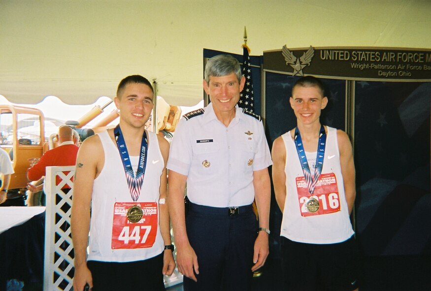 WRIGHT-PATTERSON AIR FORCE BASE, Ohio -- Airmen 1st Class Tanner Bryan and Anton Shevchenko, Moody's Air Force Marathon Team members, pose with General Norton A. Schwartz, Air Force Chief of Staff. (Courtesy photo)