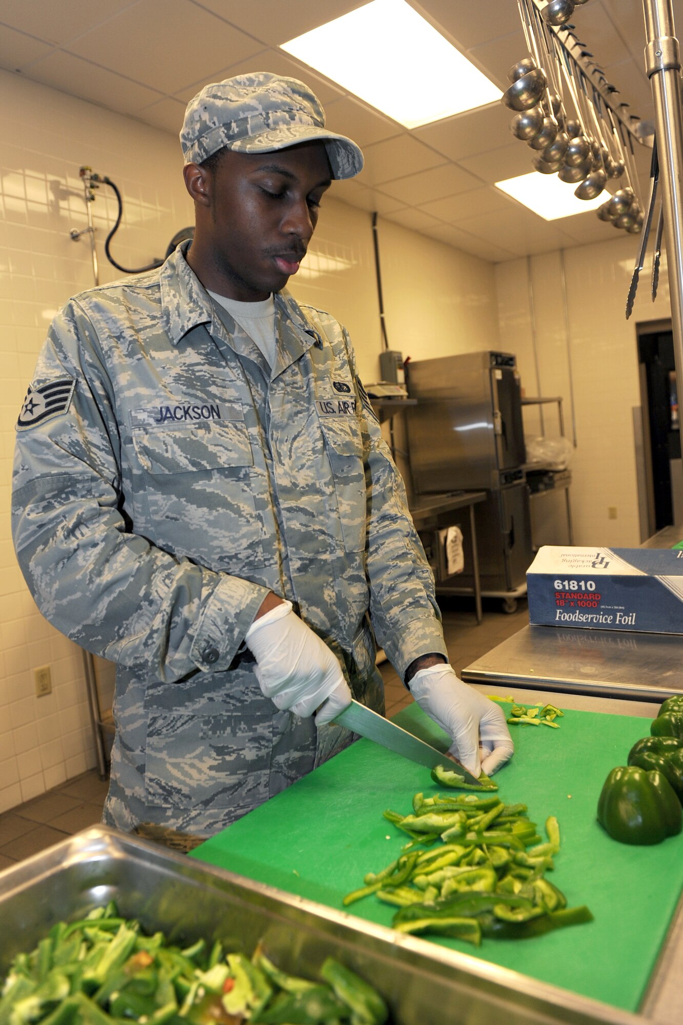 Staff Sgt. Sterling Jackson, 19th Force Support Squadron food services, slices green bell peppers Oct. 27 for the salad bar at the Hercules Dining Facility on base. (U.S. Air Force photo by Senior Airman Ethan Morgan)