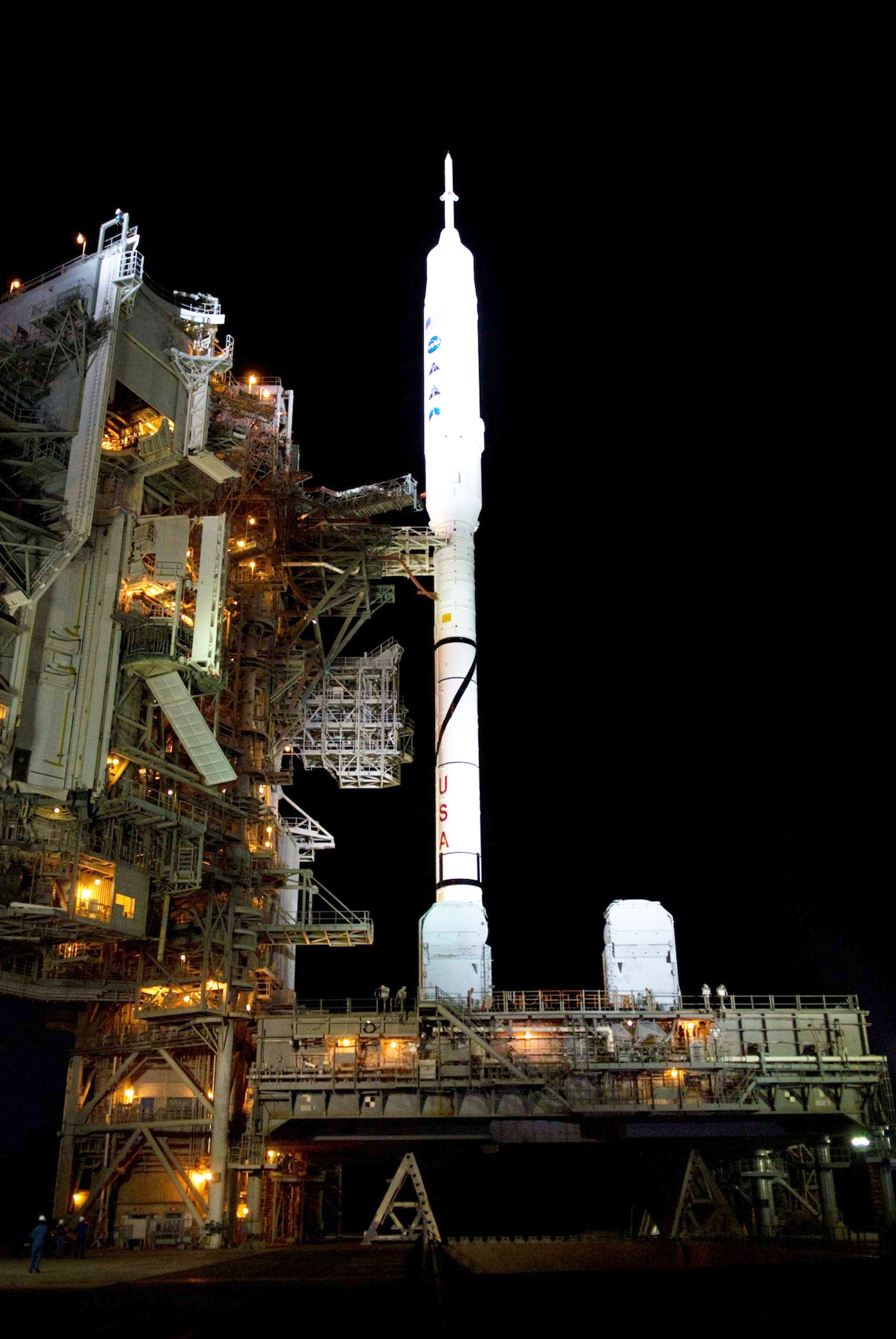 As nightfall comes to Launch Complex 39B at NASA's Kennedy Space Center in Florida, xenon lights reveal the Ares I-X rocket awaiting the approaching liftoff of its flight test. This is the first time since the Apollo Program's Saturn rockets were retired that a vehicle other than the space shuttle has occupied the pad.  The rocket eventually was launched Oct. 28, 2009 (NASA photo/Kim Shiflett)