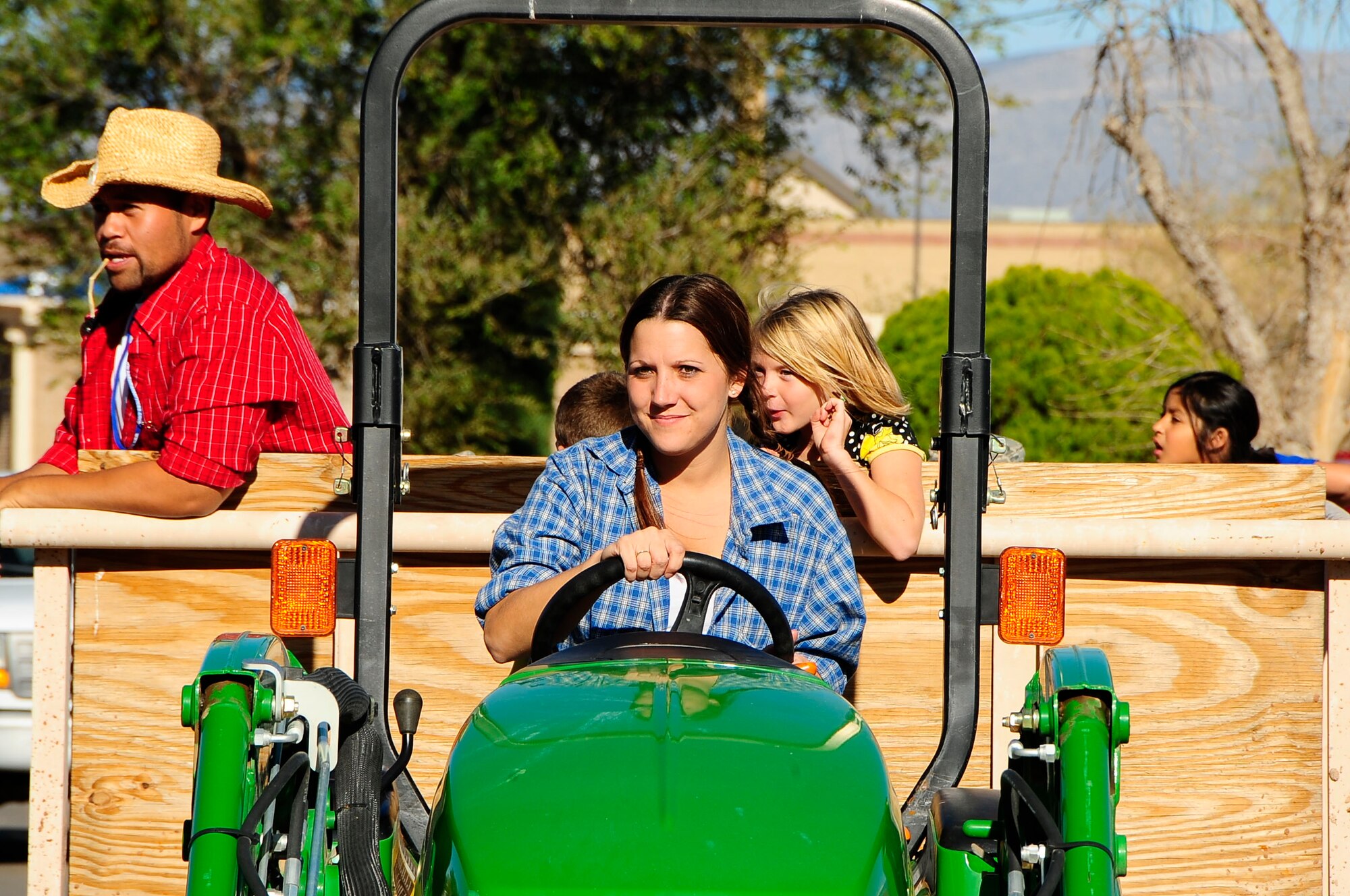 HOLLOMAN AIR FORCE BASE, N.M. -- Amber Rolph, 49th Force Support Squadron, provides hayrides for Team Holloman members during the fall festival at Steinhoff Park here Oct. 23. More than 400 Team Holloman members attended the event during the day-long 49th Fighter Wing Next Generation Celebration. (U.S. Air Force photo by Tech. Sgt. Chris Flahive)