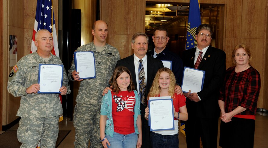 BISMARCK, N.D.  -- N.D. Governor John Hoeven stands with the recipients of the Day of the Deployed proclamation here, Oct. 26. The 4th annual Day of the Deployed ceremony is part of an active way to support our brothers in arms who are sent overseas in order to protect the freedoms of America and her allies. (U.S. Air Force photo by Senior Airman Michael Veloz)