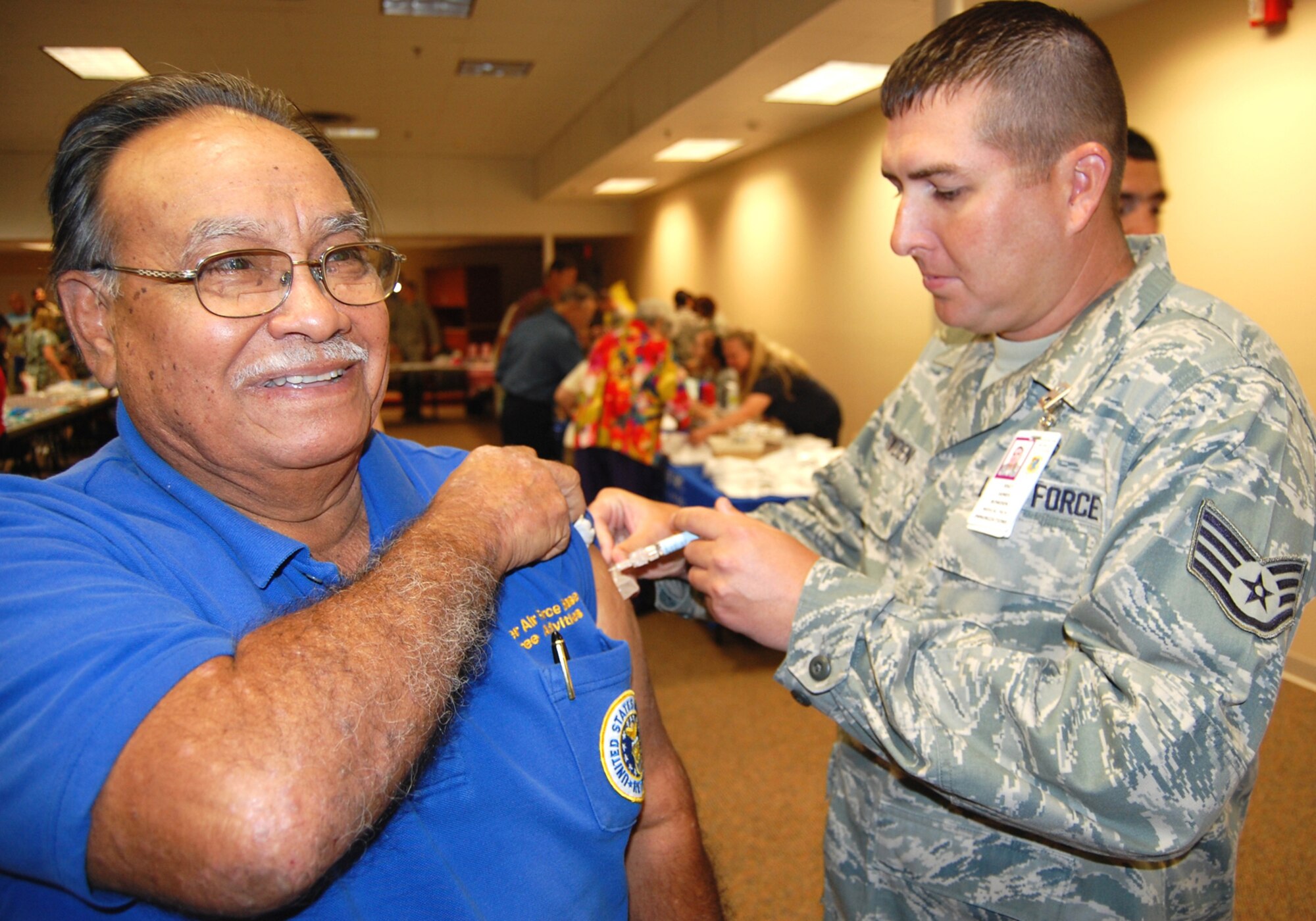 Retired Tech. Sgt. Miguel Saavedra gets a seasonal flu shot from Staff Sgt. James Bowden, 81st MDOS, during Friday’s Retiree Appreciation Day.  Representatives from the 81st Medical Group, legal office, MyPay, personnel, finance, the commissary and the base exchange were on hand for the annual event at the Dragon’s Lair.  (U.S. Air Force photo by Steve Pivnick)