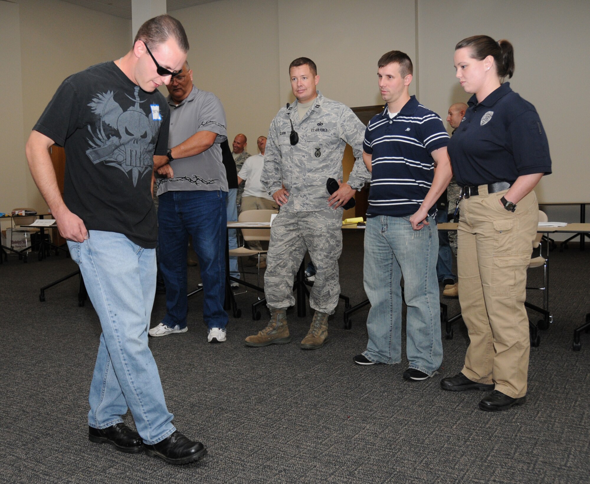 From left, Staff Sgt. Jeremy Christian, 81st Training Group, does the “walk and turn” sobriety test Oct. 21 observed by Jim Cazzell, Gautier Police Department traffic officer; Capt. Jim Clark, 81st SFS commander; Phillip Carden, Long Beach Police Department patrolman; and Regina McLendon, Lucedale Police Department DUI?officer.  (U.S. Air Force photo by Kemberly Groue)