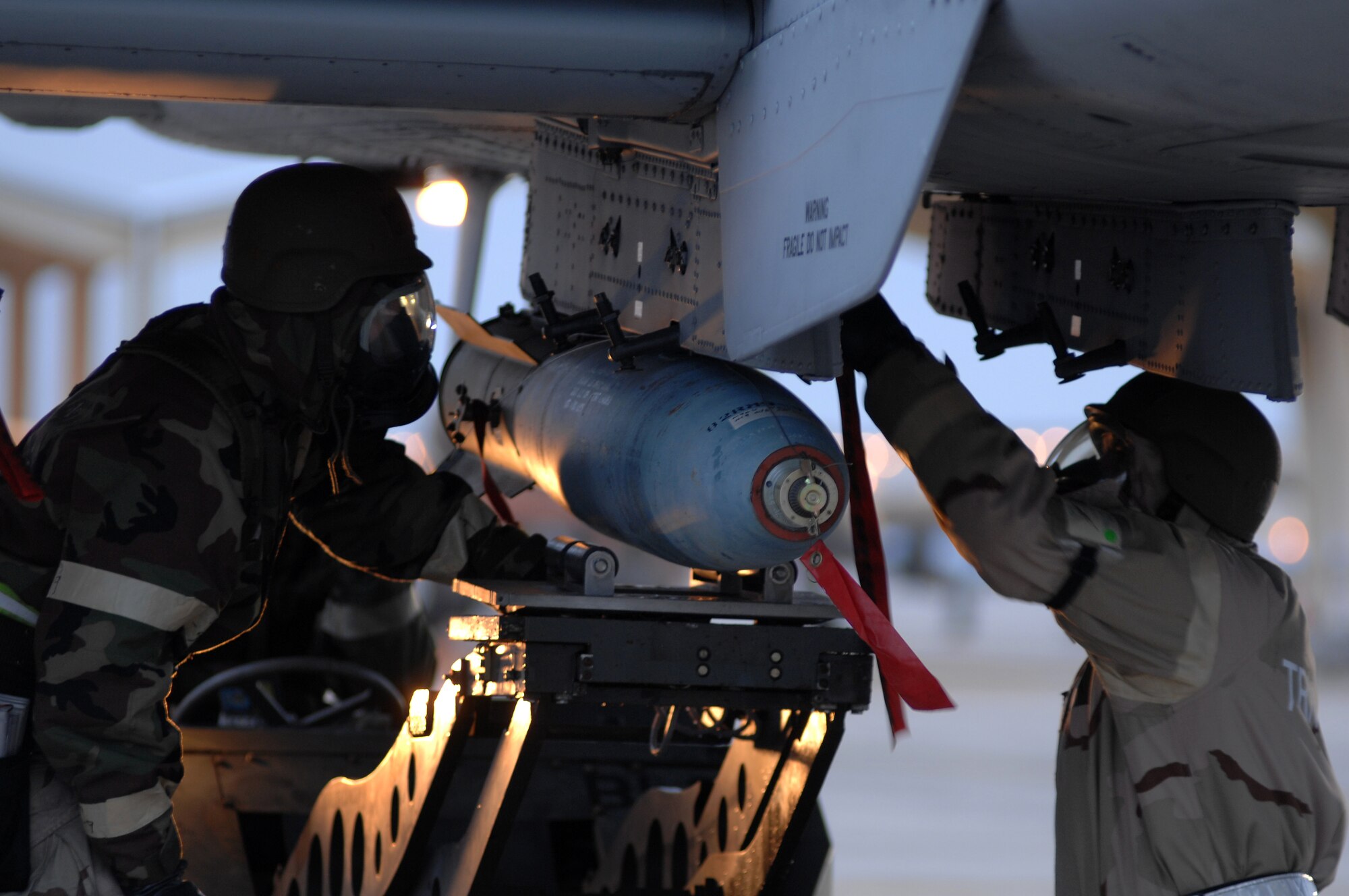 WHITEMAN AIR FORCE BASE, Mo. - Tech Sgt. John Straka and Senior Airman James Register, 442nd Fighter Wing, load munitions onto an A-10 Thunderbolt II during an Operational Readiness Inspection, Oct. 26. 442nd Fighter Wing personnel worked around the clock in cold and wet weather conditions during the four day exercise. The ORI prepared Airmen for real-world deployment situations such as chemical and biological attacks and other scenarios. (U.S. Air Force photo/Senior Airman Kenny Holston)(Released) 