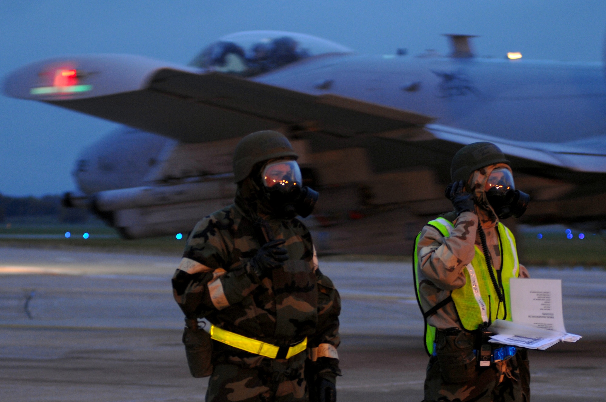WHITEMAN AIR FORCE BASE, Mo.  Master Sgts. Richard Olnner and Sam Bossallar, 442nd Fighter Wing crew chiefs, communicate with pilots and other crew chiefs to launch A-10 Thunderbolt IIs during an Operational Readiness Inspection, Oct. 26. 442nd FW personnel worked around the clock in cold and wet weather conditions during the four-day exercise. The ORI prepared Airmen for real-world deployment situations such as chemical and biological attacks and other scenarios. (U.S. Air Force photo/Senior Airman Kenny Holston)(Released) 
